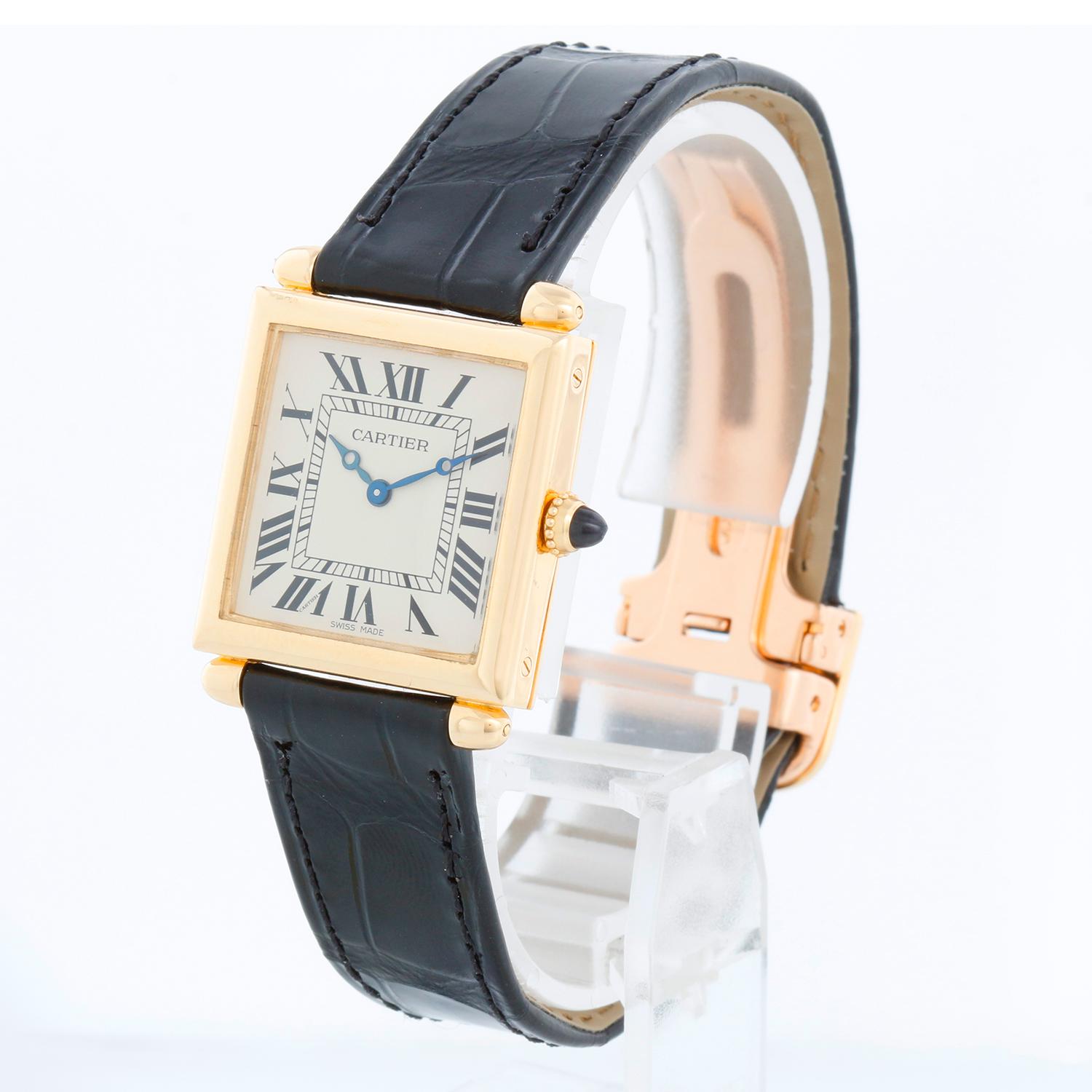 Cartier Tank Obus Men's or Ladies 18k Yellow Gold Watch WB800151 1630 - Quartz. 18k Yellow gold case (25mm x 32mm). Ivory dial with black Roman numerals. Black Cartier bracelet with 18K yellow gold Cartier deployant clasp. Pre-owned with custom box.