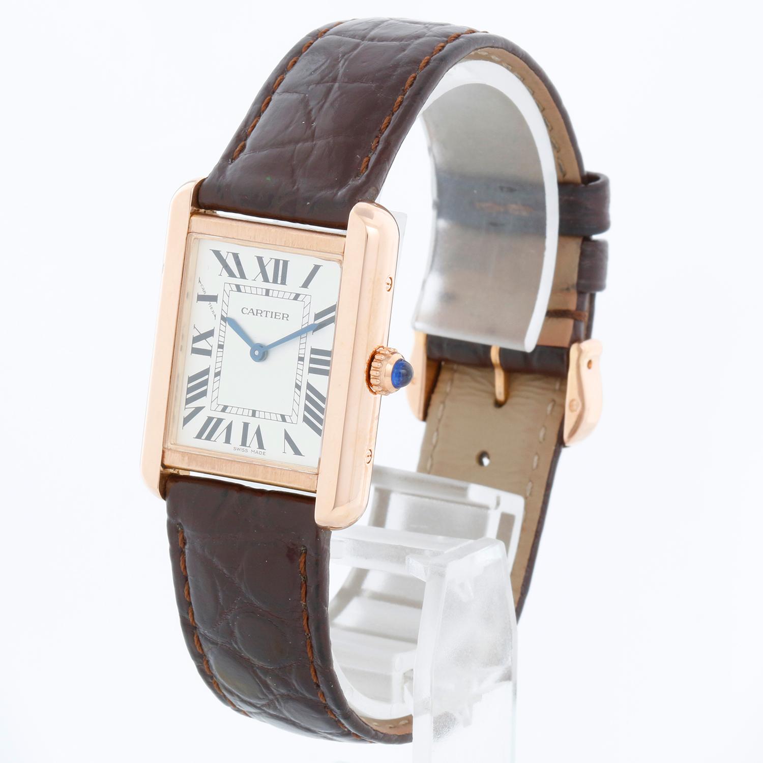 Cartier Tank Solo 18K Rose Gold Ladies Watch W5200024 3168 - Quartz movement. 18k rose gold case with stainless steel back  (24 mm x 31mm). Silver dial with black Roman numerals. Brown  Cartier strap with Cartier rose gold tang buckle. Pre-owned
