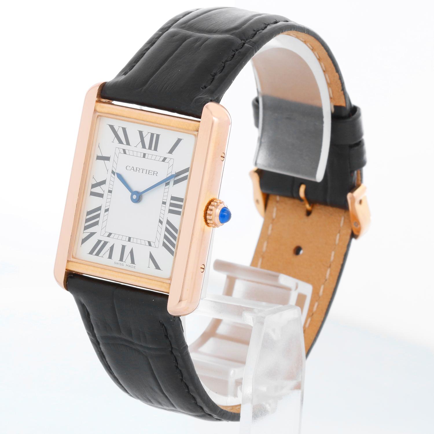 Cartier Tank Solo 18k Rose Gold Men's Watch W5200025 - Quartz movement. 18k Rose gold case with stainless steel back (27mm x 34mm). Silver dial with black Roman numerals. Black strap band with 18k yellow gold Cartier buckle. Pre-owned with custom