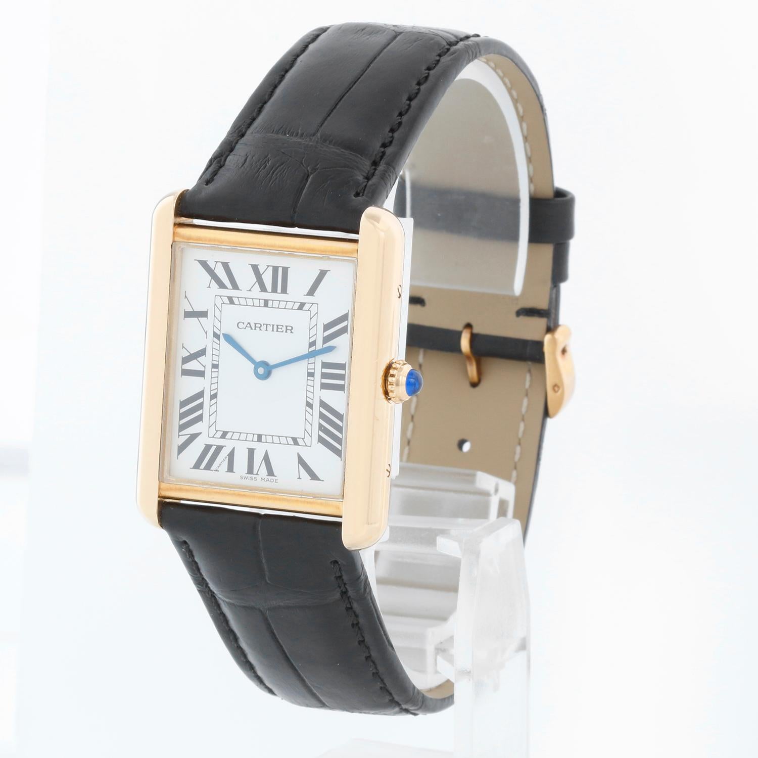Cartier Tank Solo 18K Yellow Gold Men's Watch W1018855 2742 - Quartz movement. 18k yellow gold case with stainless steel back (27mm x 34mm). Silver colored dial with black Roman numerals. New Black Cartier strap band with 18k yellow gold Cartier