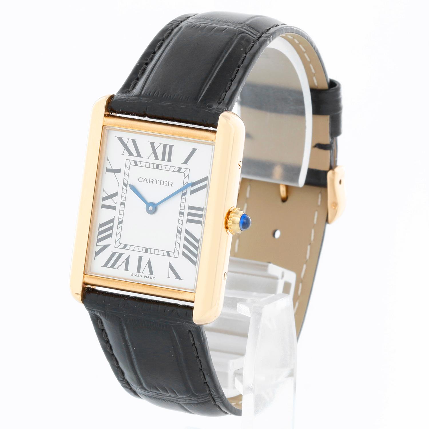 Cartier Tank Solo 18k Yellow Gold Men's Watch W1018855 - Quartz movement. 18k yellow gold case with stainless steel back (27mm x 34mm). White dial with black Roman numerals. Black Cartier strap band with 18k yellow gold Cartier buckle. Pre-owned