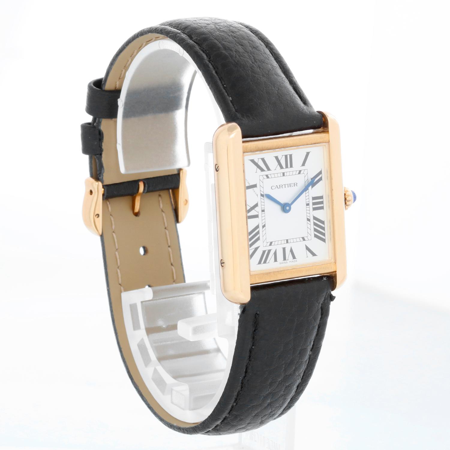 Cartier Tank Solo 18K Yellow Gold Men's Watch W5200002 3168 - Quartz movement. 18k yellow gold case with stainless steel back  (24 mm x 31mm). Silver dial with black Roman numerals. Black Cartier strap with yellow gold tang buckle. Pre-owned with