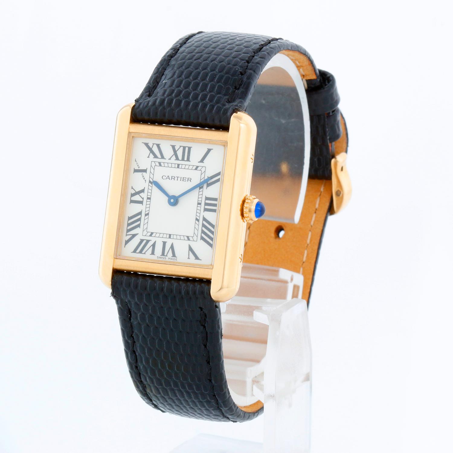 Cartier Tank Solo 18K Yellow Gold Men's Watch W5200002 3168 - Quartz movement. 18k yellow gold case with stainless steel back  (24 mm x 31mm). Silver dial with black Roman numerals. Black Cartier strap with yellow gold tang buckle. Pre-owned with