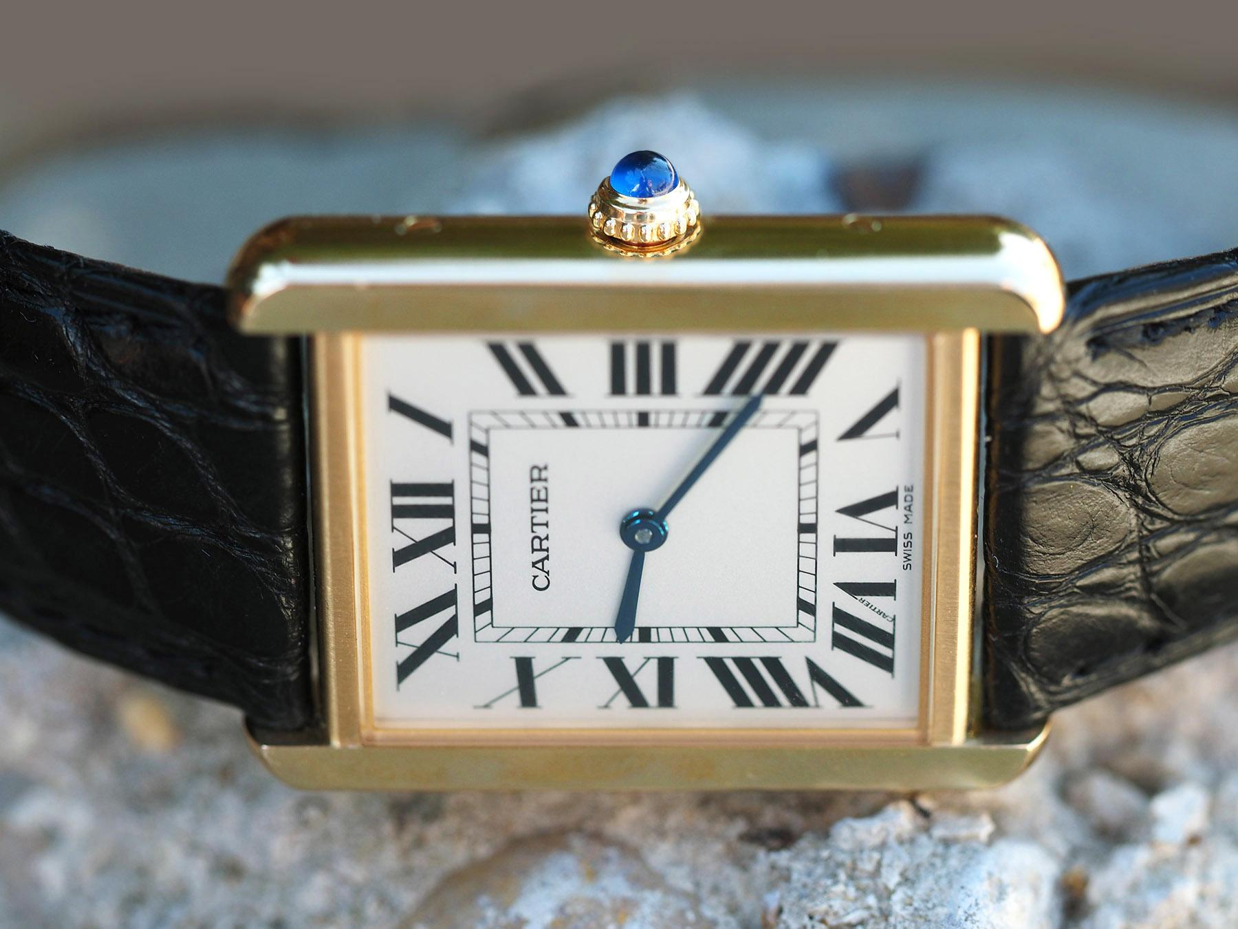Quantity One (1) Cartier Tank Solo 18k Yellow Gold Quartz Watch (size Large) with Steel Back and an original Cartier black leather band.

The watch comes with the inner red gift box, pillow, and owner's manual.

The watch also comes with the outer