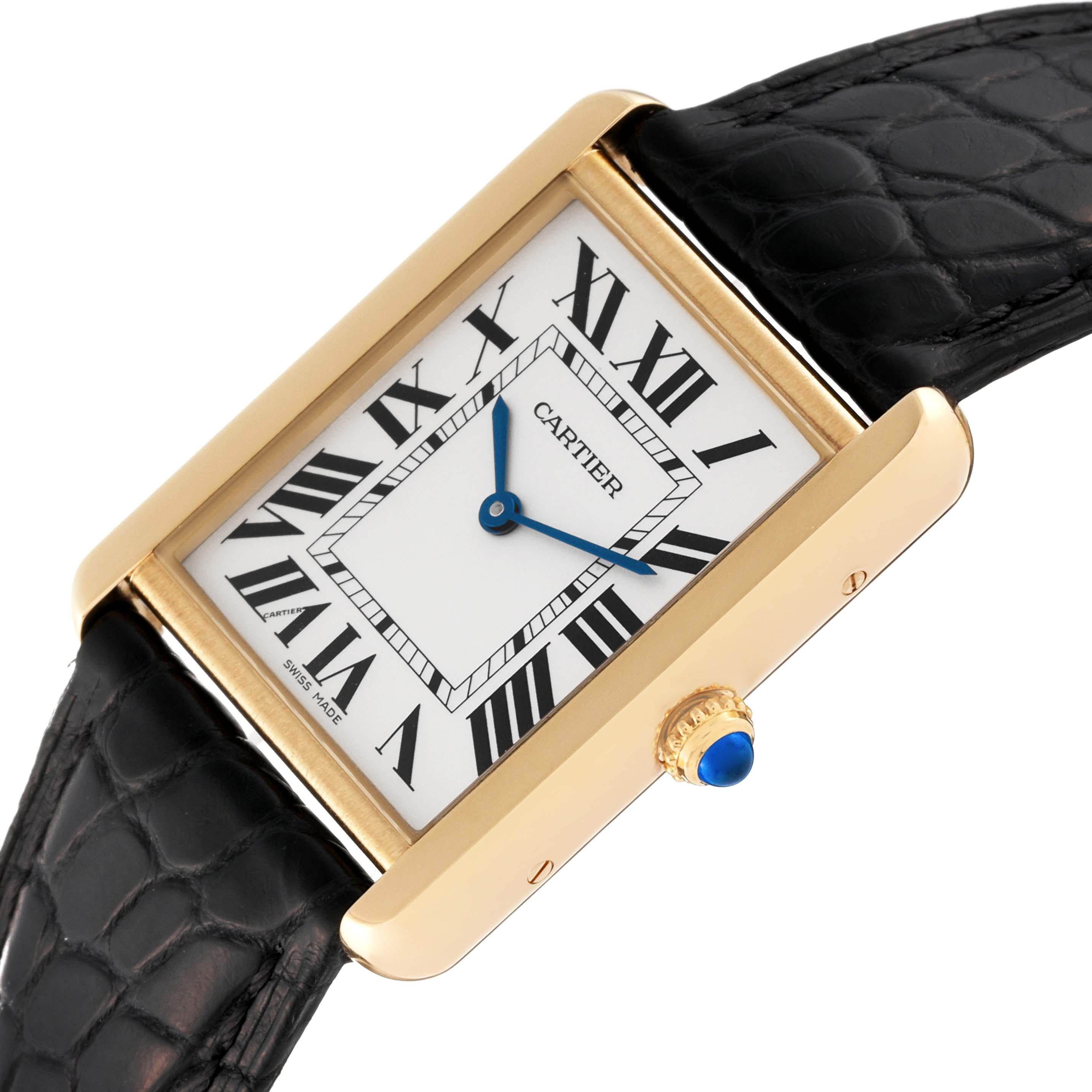 Cartier Tank Solo Large Yellow Gold Steel Mens Watch W5200004 Card. Quartz movement. 18k yellow gold case 34 mm x 27 mm. Stainless steel caseback. Circular grained crown set with a blue spinel cabochon. . Scratch resistant sapphire crystal. Silver