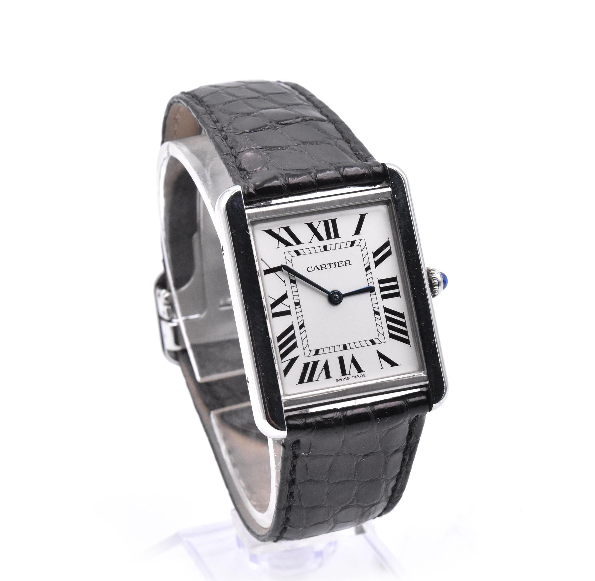 Movement: automatic
Function: hours, minutes
Case: 34.8 mm x 27.4 mm case, push pull crown, sapphire crystal
Dial: white dial, blue steeled hands, roman numeral hour markers
Band: Cartier leather band with butterfly clasp
Serial #:
