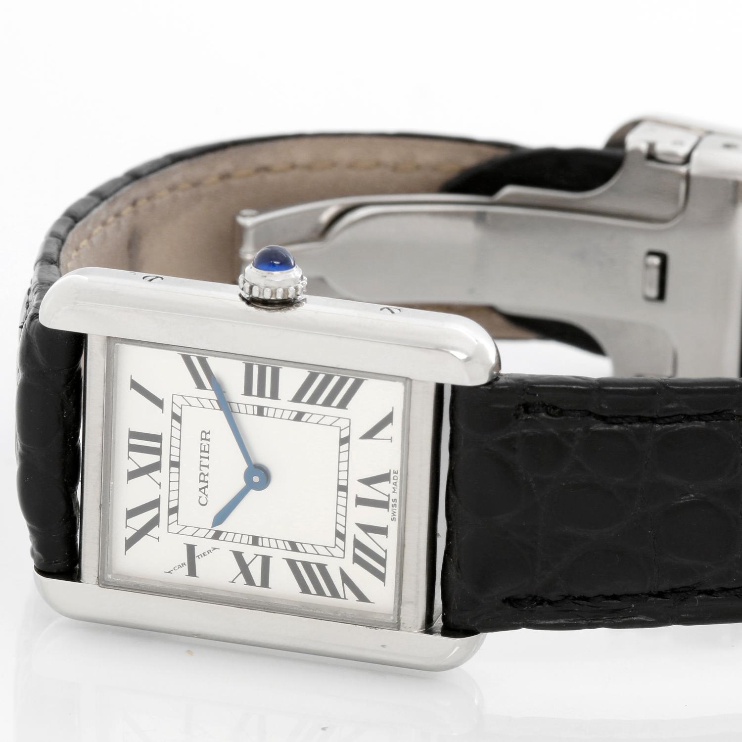 Cartier Tank Solo Stainless Steel Ladies Watch W520005 - Quartz. Stainless steel case (24mm x 30mm). Silver dial with black Roman numerals. Black strap band with Cartier deployant buckle . Pre-owned with Cartier papers