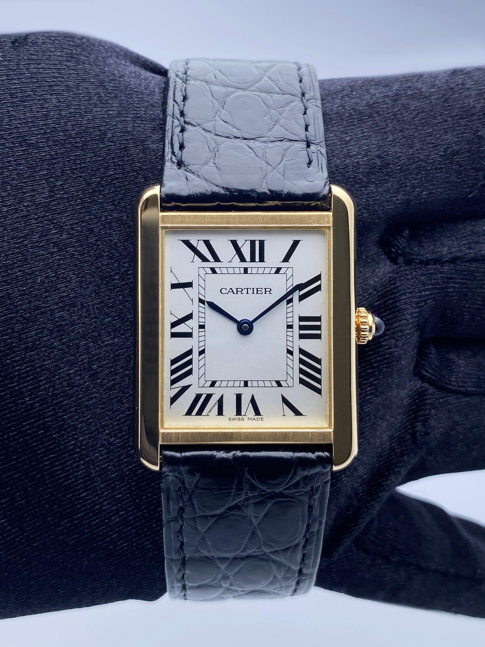 Cartier Tank Solo W5200004 / 3167 Ladies Watch.¬†28mm 18K¬†yellow gold¬†case. Sliver¬†dial with blue steel hands and Roman numeral hour markers. Minute markers on the inner dial. Black¬†leather strap¬†with 18K¬†yellow gold buckle. Will fit up to a