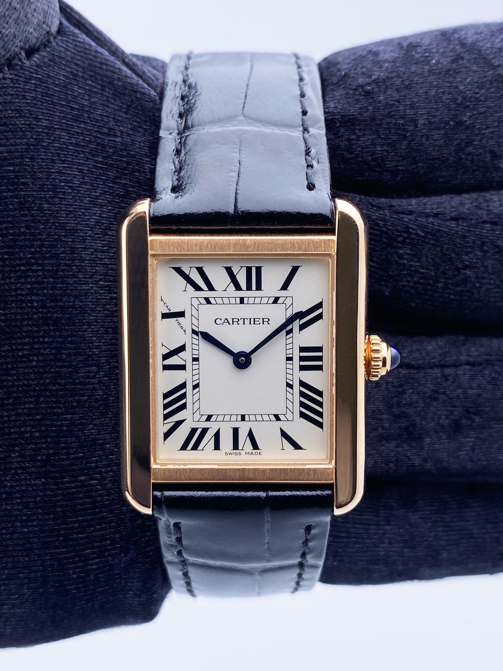 Cartier Tank Solo W5200024 Watch. 24mm 18K rose gold case. Sliver dial with blue steel hands and Roman numeral hour markers. Minute markers on the inner dial. Black leather strap with 18K rose gold buckle. Will fit up to a 7-inch wrist. Sapphire