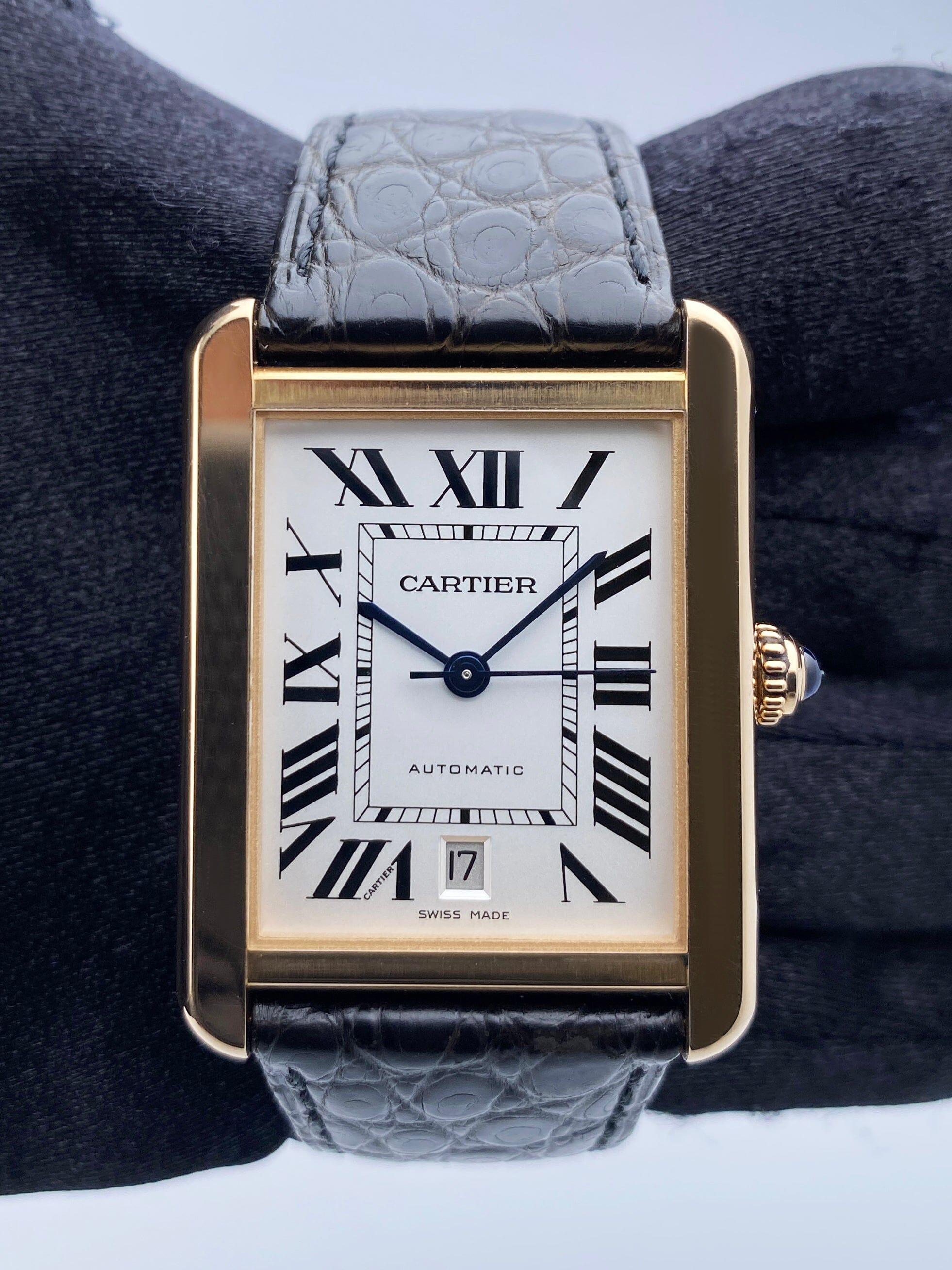 Cartier Tank Solo XL W5200026 / 3514 Mens Watch. 31mm 18K rose gold case with smoothed 18K rose gold bezel. Silver dial with blue steel hands and Roman numeral hour markers. Minute markers around an inner dial. Date display at the 6 o'clock