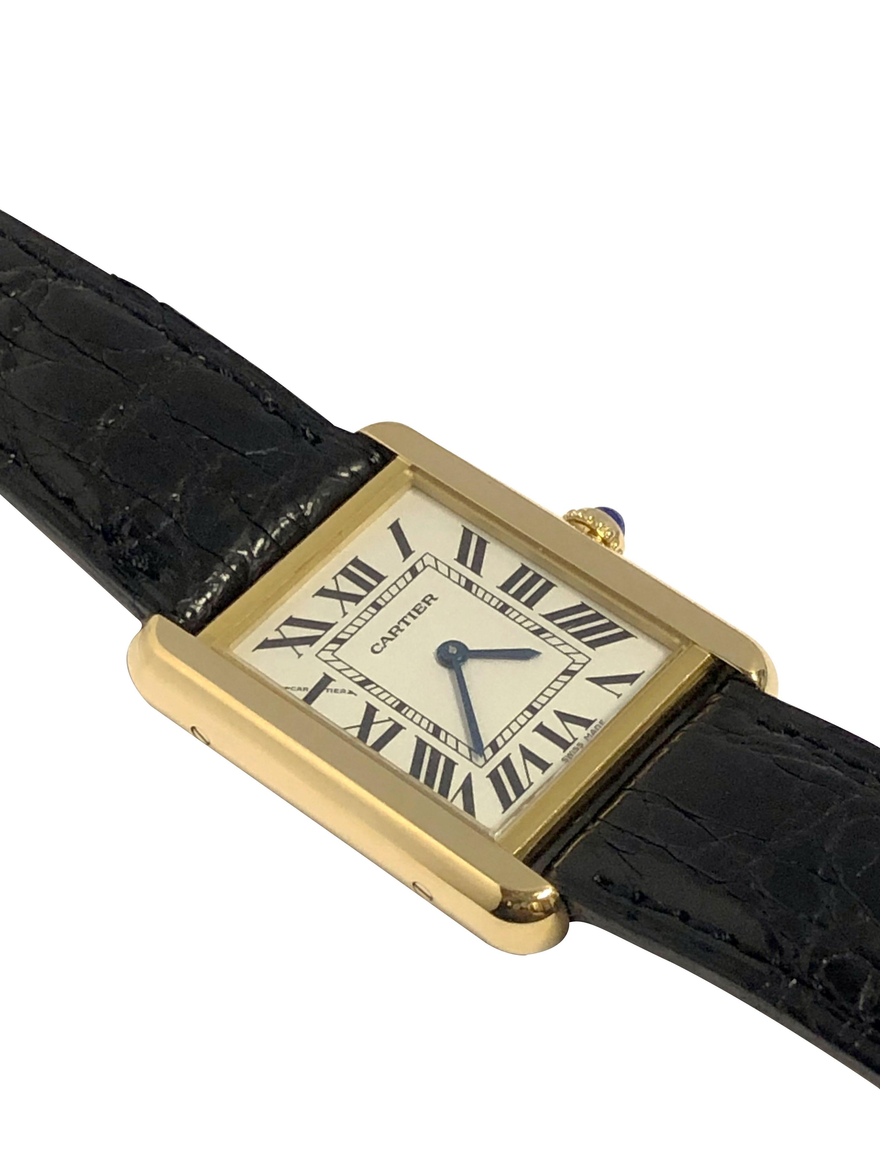 Circa 2015 Cartier Tank Solo Reference 2743 Wrist Watch, 24 x 24 M.M. 2 piece 18k Yellow Gold with Stainless Steel back water resistant case. Quartz Movement, Silver White Dial with Black Roman numerals, Sapphire set crown.  Original Croco Grain