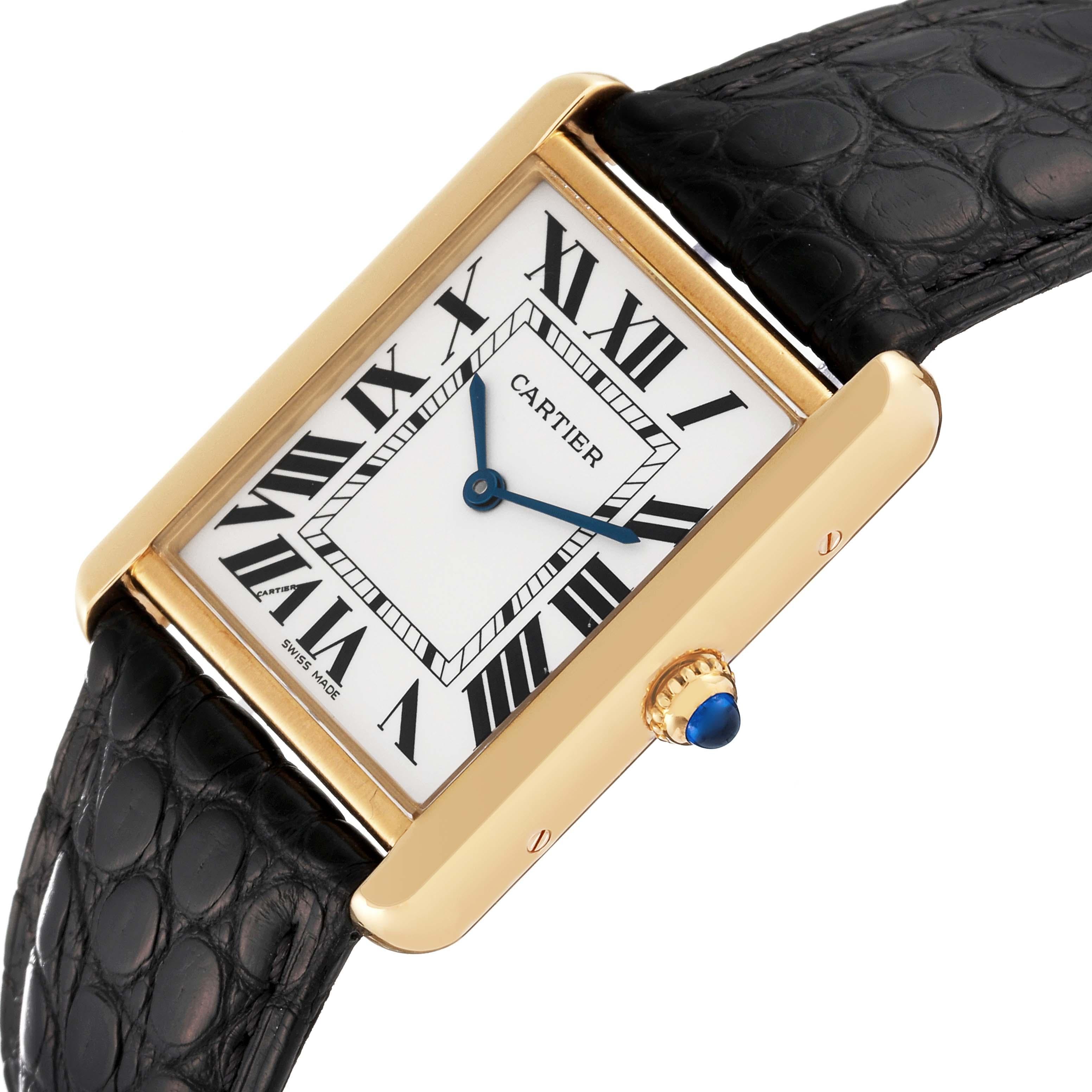 Cartier Tank Solo Yellow Gold Steel Black Strap Mens Watch W1018855 Card. Quartz movement. 18k yellow gold case 34.0 x 27.0 mm. Stainless steel caseback. Circular grained crown set with a blue spinel cabochon. . Scratch resistant sapphire crystal.