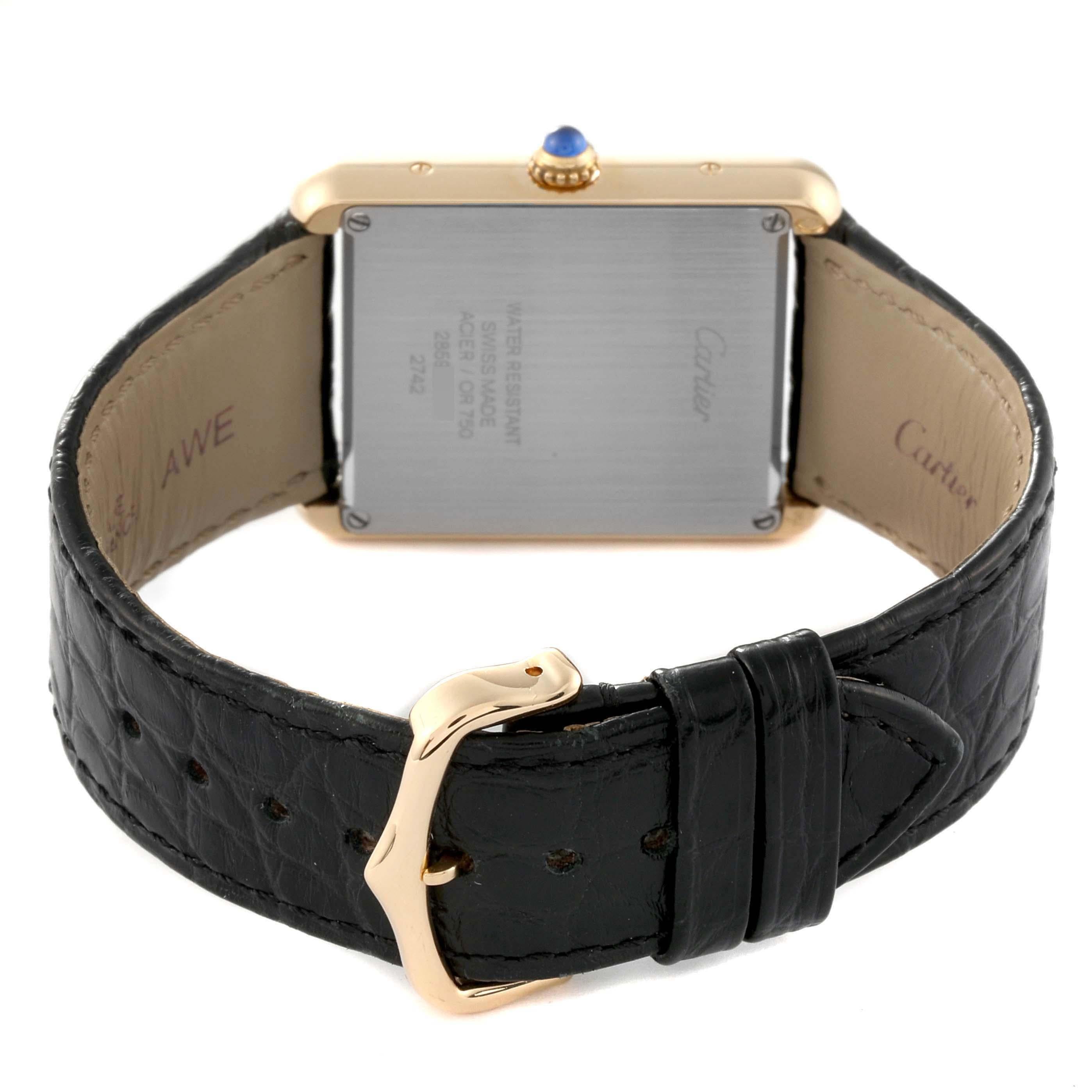 Cartier Tank Solo Yellow Gold Steel Black Strap Mens Watch W1018855. Quartz movement. 18k yellow gold case 34.0 x 27.0 mm. Stainless steel caseback. Circular grained crown set with a blue spinel cabochon. . Scratch resistant sapphire crystal. Silver