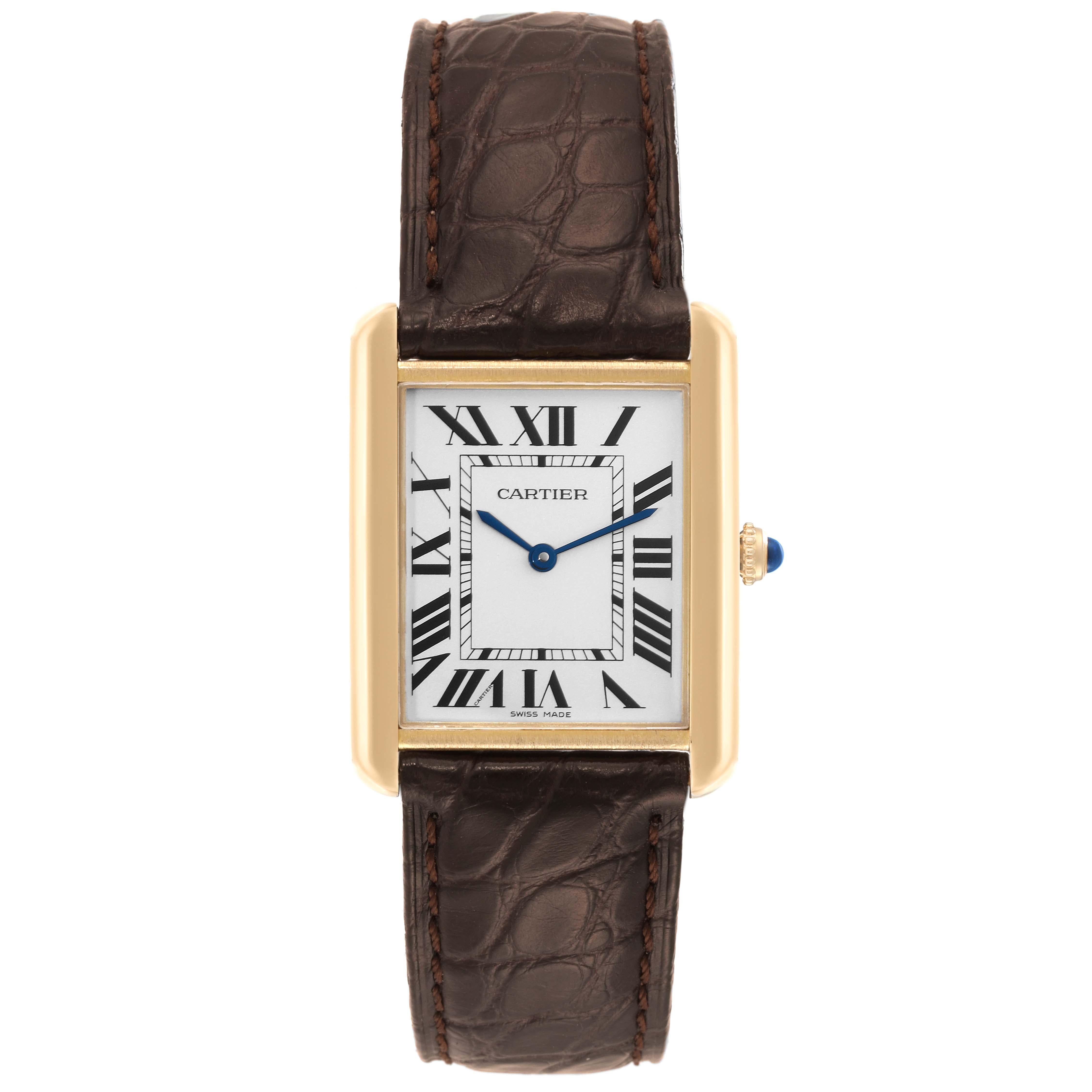 Cartier Tank Solo Yellow Gold Steel Brown Strap Mens Watch W1018855. Quartz movement. 18k yellow gold case 34.0 x 27.0 mm with stainless steel caseback. Circular grained crown set with a blue spinel cabochon. . Scratch resistant sapphire crystal.