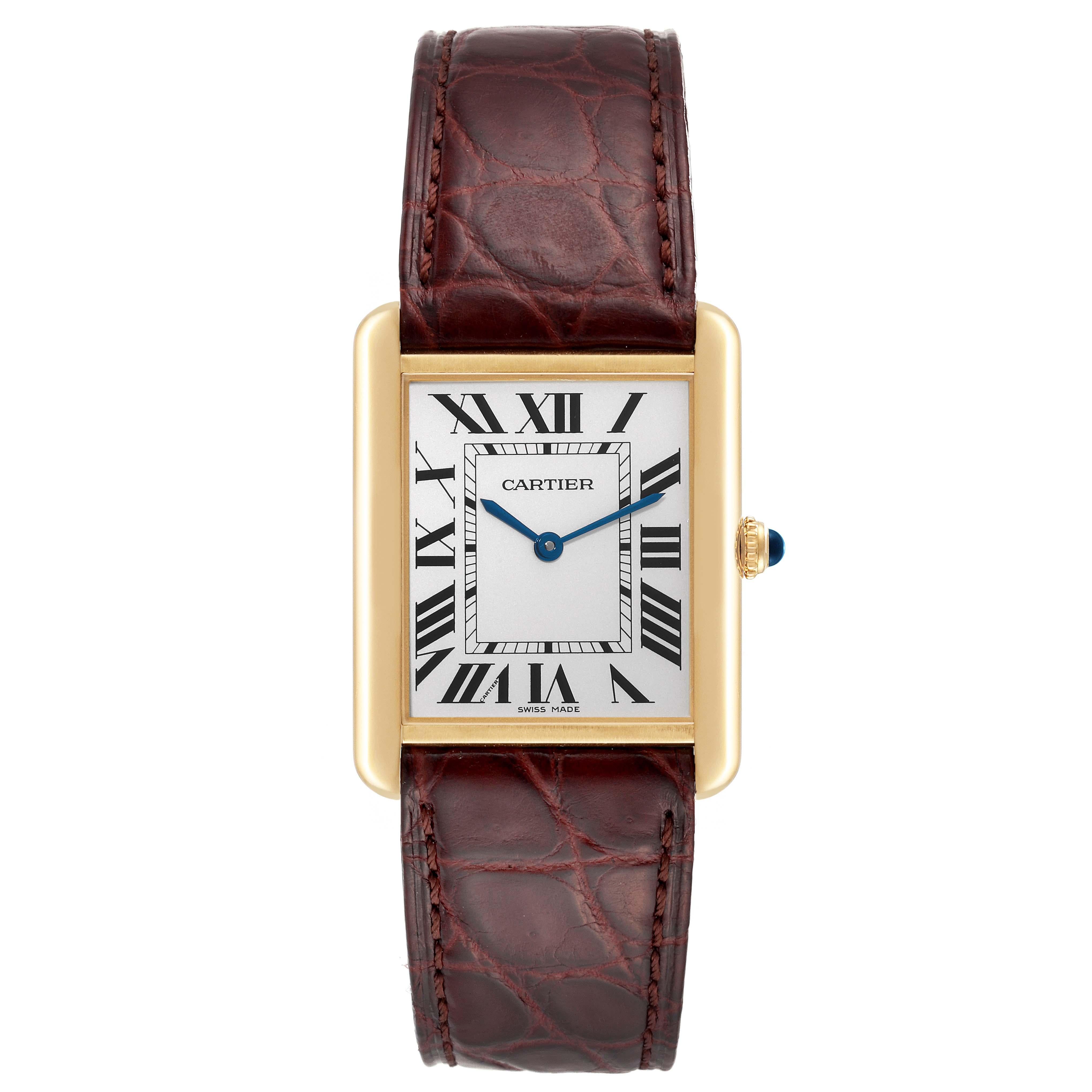 Cartier Tank Solo Yellow Gold Steel Brown Strap Mens Watch W1018855. Quartz movement. 18k yellow gold case 34.0 x 27.0 mm. Stainless steel caseback. Circular grained crown set with a blue spinel cabochon. . Scratch resistant sapphire crystal. Silver