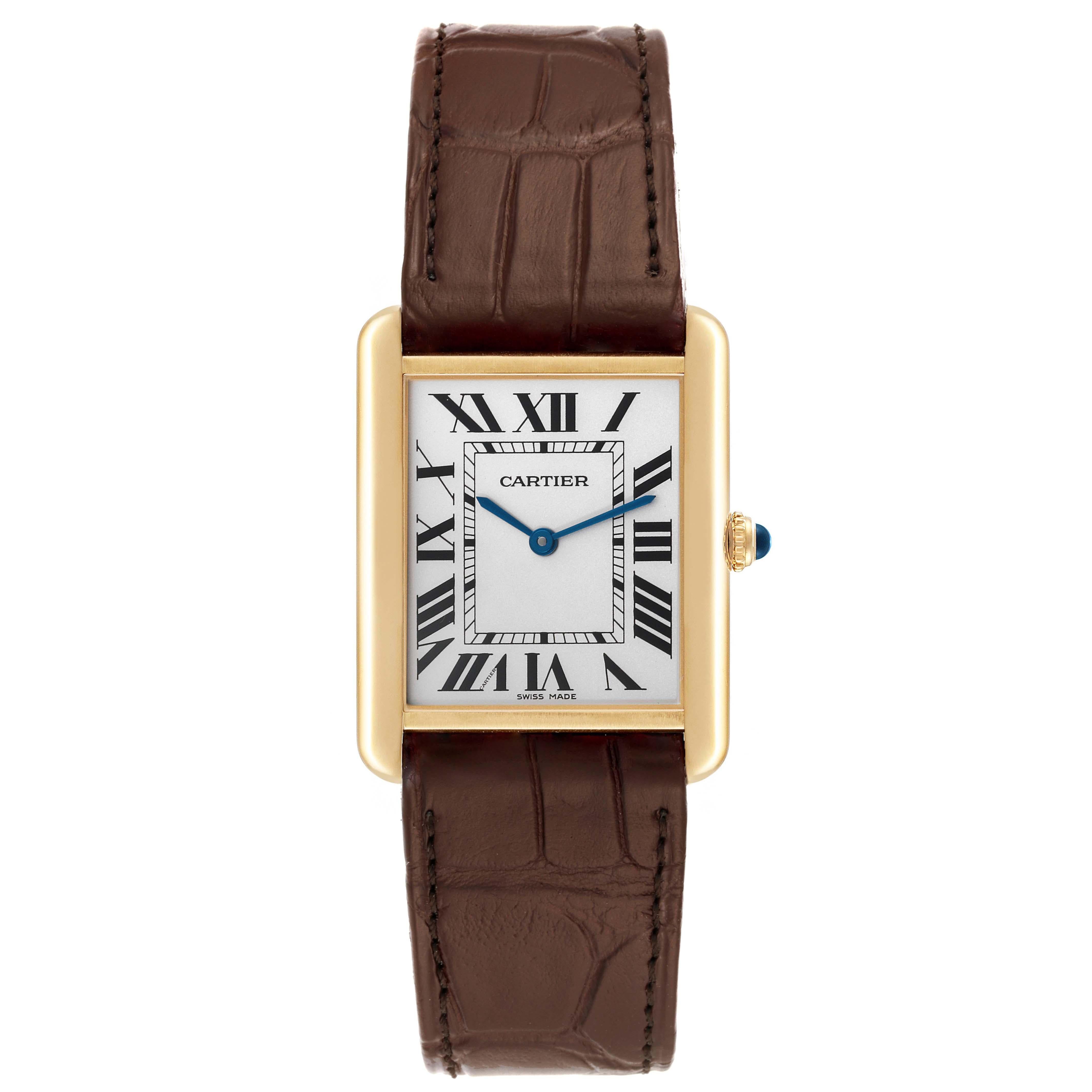 Cartier Tank Solo Yellow Gold Steel Brown Strap Mens Watch W1018855. Quartz movement. 18k yellow gold case 34.0 x 27.0 mm. Stainless steel caseback. Circular grained crown set with a blue spinel cabochon. . Scratch resistant sapphire crystal. Silver