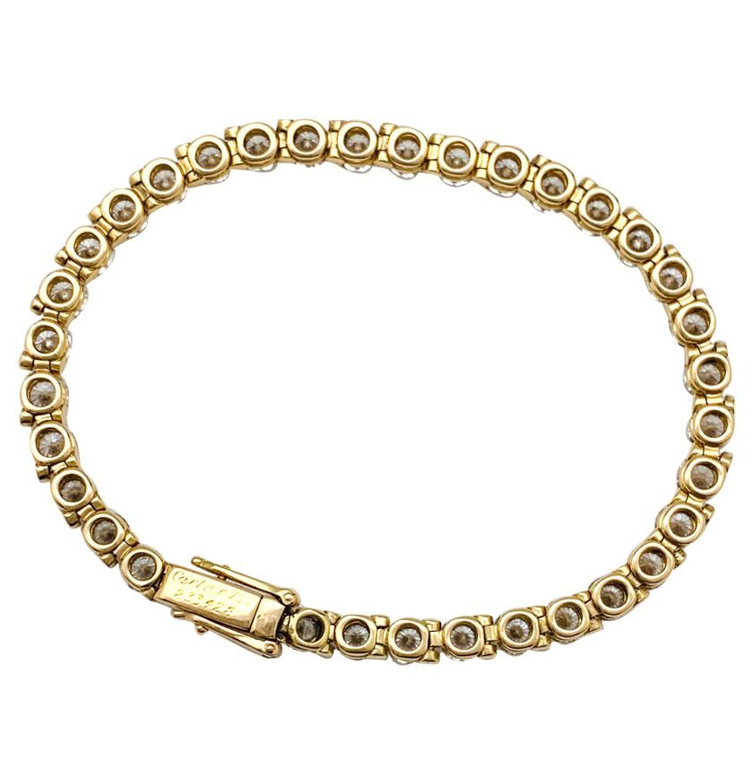 Cartier tennis bracelet, 18Kt yellow gold, entirely set with 36 brilliant cut diamonds. 
Two security system on the clasp.
Signed and numbered, Hallmarks.
Length : 160 mm
Weight : 12.5 grams