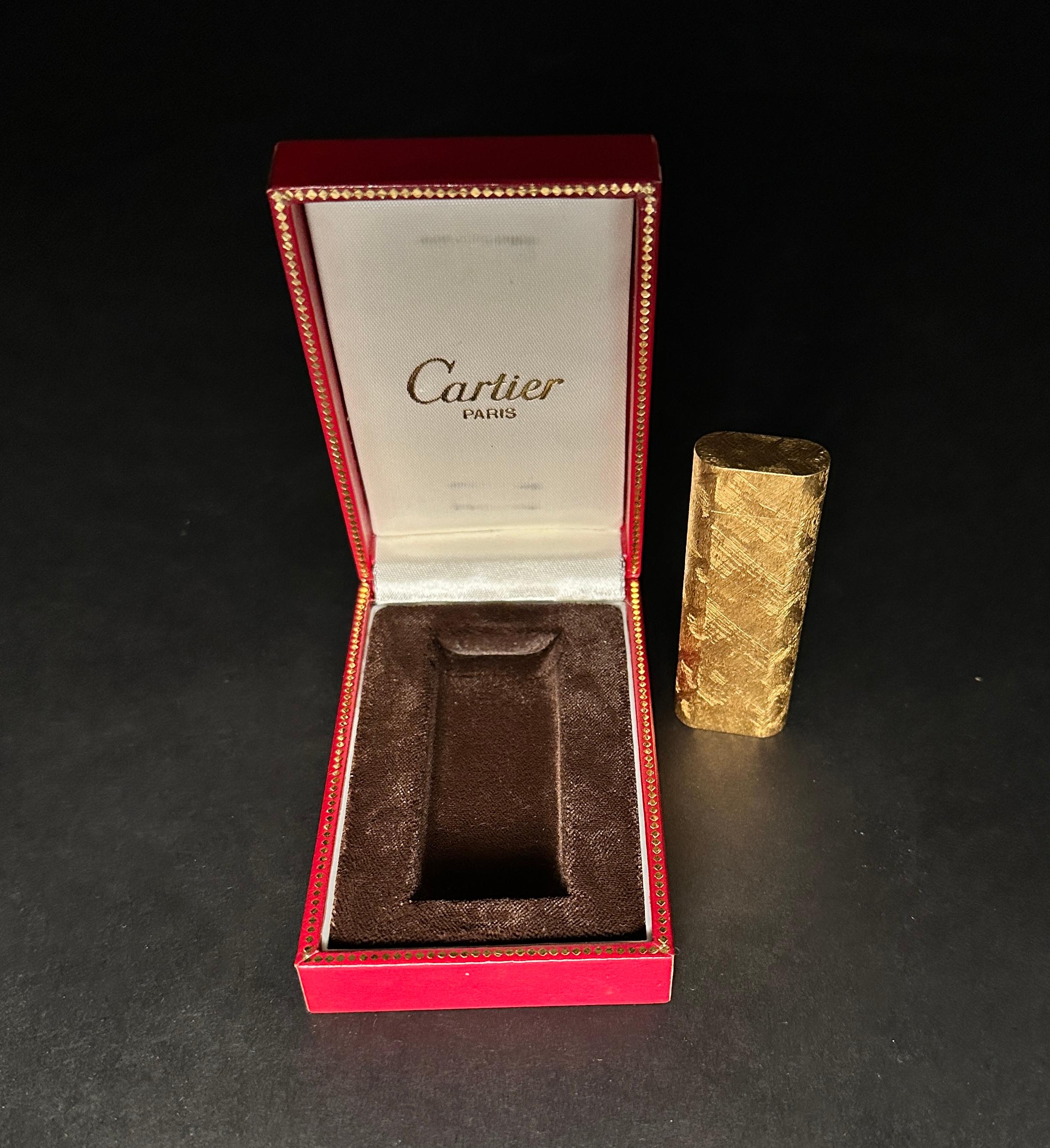  Vintage classic gold-plated Cartier lighter with a geometric frosted textured design. Inscribed with 'Cartier Paris'  and numbered on bottom: Cartier PARIS. Swiss made. Marked as gold plated, PLAQUE ORG and a hallmark.