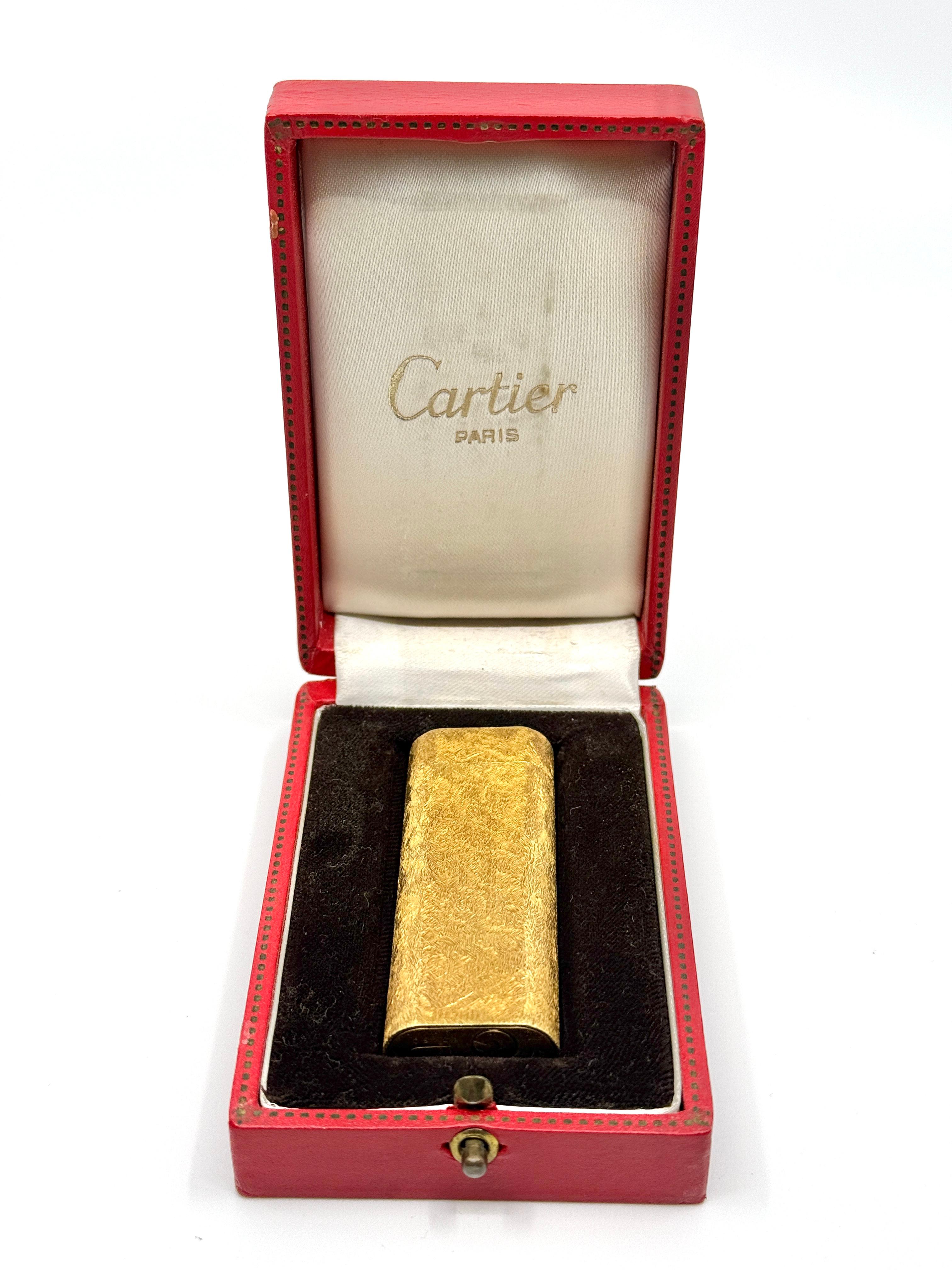 A nice Cartier Gold plated lighter in a textured pattern. It comes with its original box. There are no papers with it. The lighter functions as it should as you can see in the photos. It will be shipped without butane per postal and ups