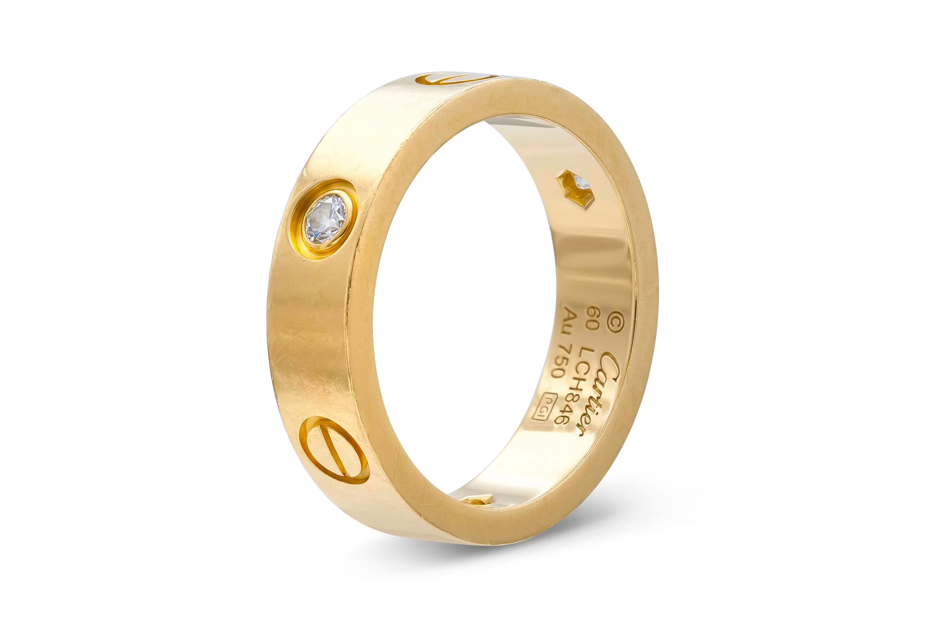 Finely crafted in 18K yellow gold with three diamonds. Signed by Cartier, from their Love collection. Size 9.