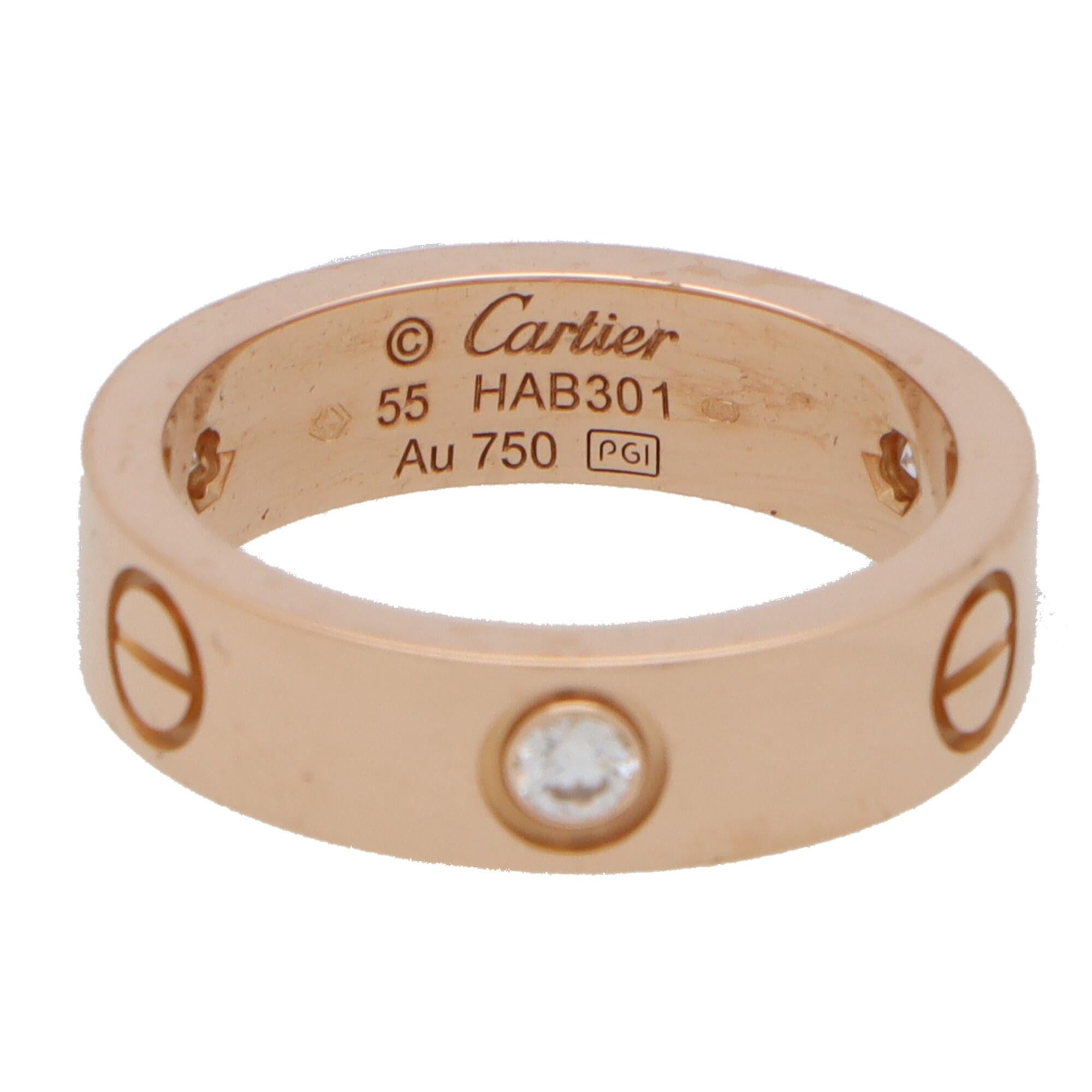  A classic three diamond Cartier Love ring set in 18k rose gold.

The ring is set in the iconic love design and instead of being stamped throughout with the nail motif is set with three additional round brilliant cut diamonds. These diamonds add a