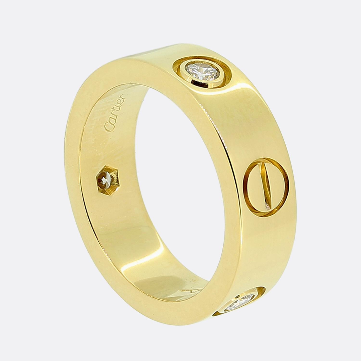 Here we have an 18ct yellow gold band ring from world the renowned luxury jewellery house of Cartier. This ring forms part of their LOVE collection and showcases three round brilliant cut diamonds alongside the iconic screw motif. This is the