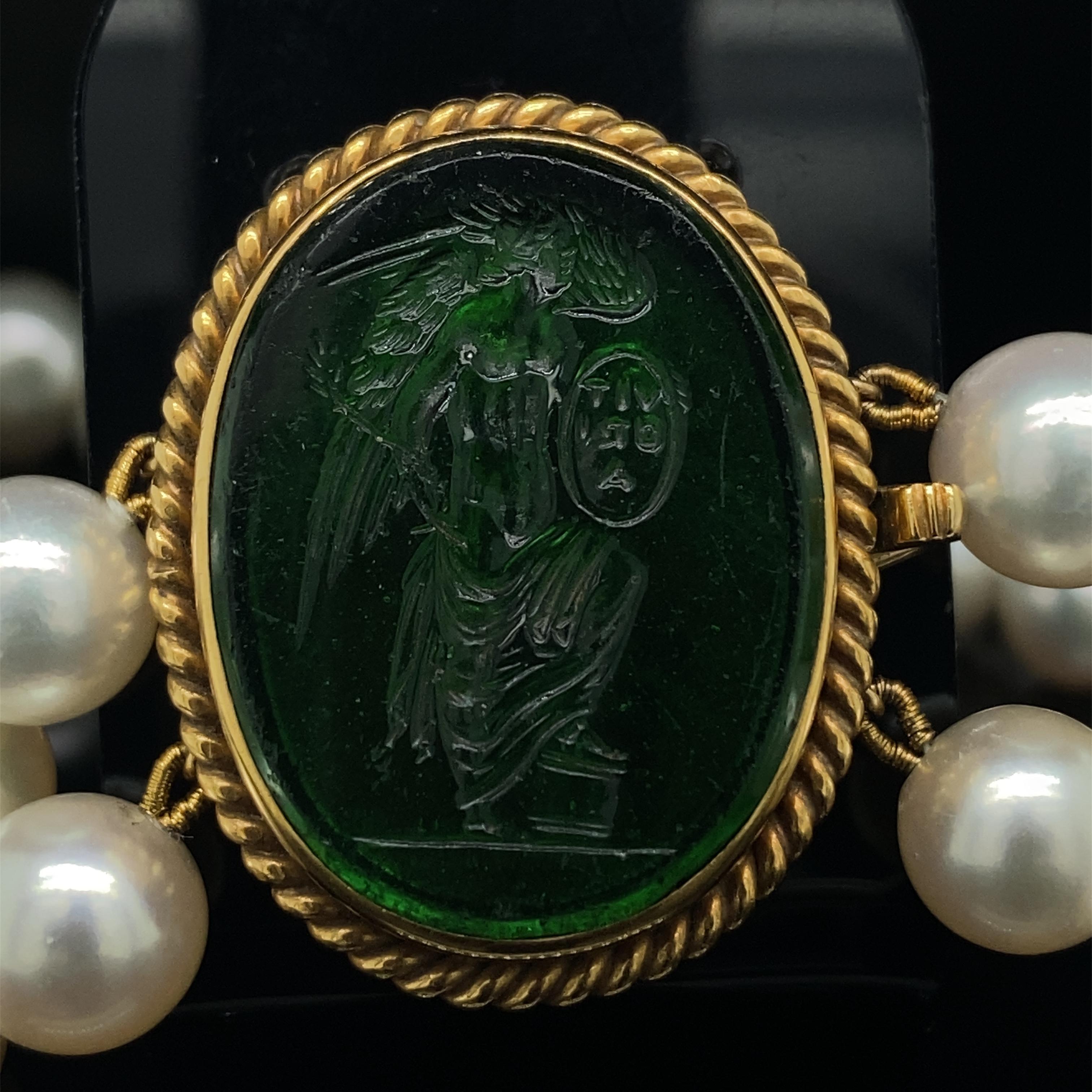 A Cartier two row pearl necklace with yellow gold hardstone revival clasp, circa 1970.

The necklace comprises of two rows of fine round cultured Pearls measuring uniformly 8.5mm approximately in diameter. The pearls are creamy white in colour,