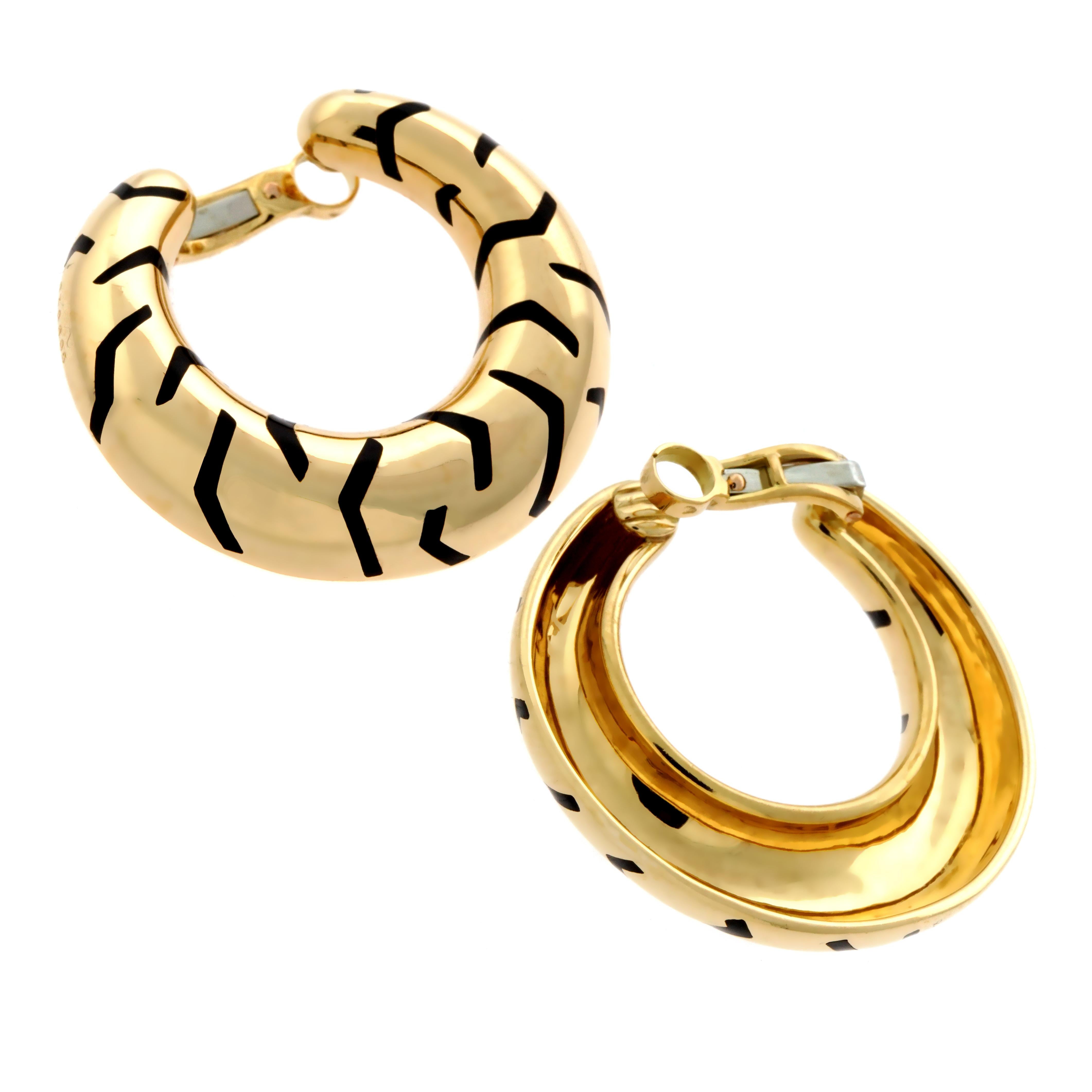 A highly collectible pair of Cartier earrings from the 1990's featuring the a chic Tiger stripe motif set with enamel in 18k yellow gold. The earrings have a circumference of 1.45