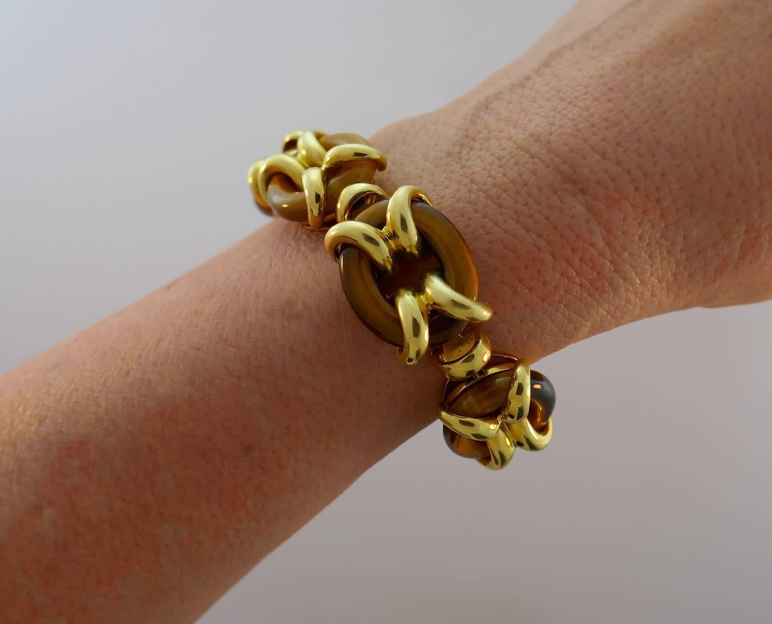 Bold yet elegant bracelet created by Cartier in 1970s. Stylish and wearable, the bracelet is a great addition to your jewelry collection. 
Made of 18 karat yellow gold and tiger's eye links. 
The bracelet measures 6-5/8 x 3/4 inches (17 x 1.8 cm)