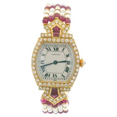Cartier Tonneau A Rare Lady's Yellow Gold, Ruby, Diamond and Pearl-Set Bracelet
