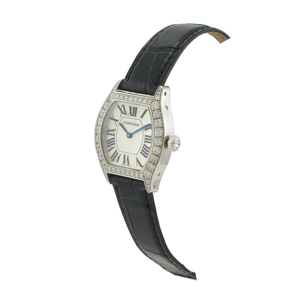 Pre-owned Cartier Tortue ref. WA507231, crafted in 18KT white gold with factory-set diamonds on the case and lugs. The 34 x 28mm tortue-shaped case features a transparent sapphire crystal case back and a signature octagonal crown set with a diamond.