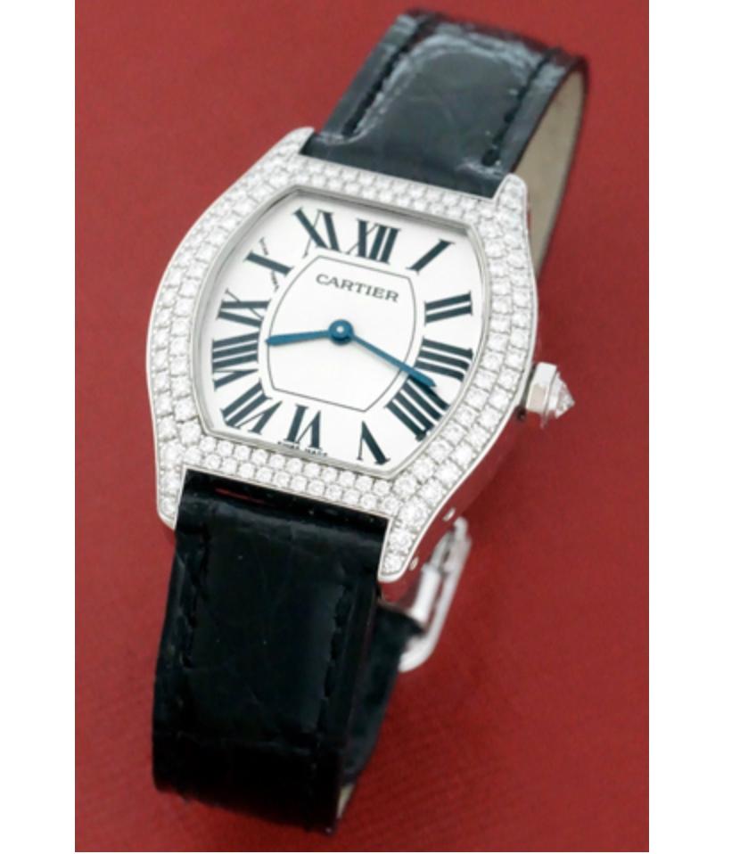 As New Cartier Tortue de Privee in absolutely stunning condition. This beautiful watch features a silver dial with black Roman numerals framed by a double row of 114 brilliant round cut diamonds weighing in at a total of 1.25 cts. The watch is cased