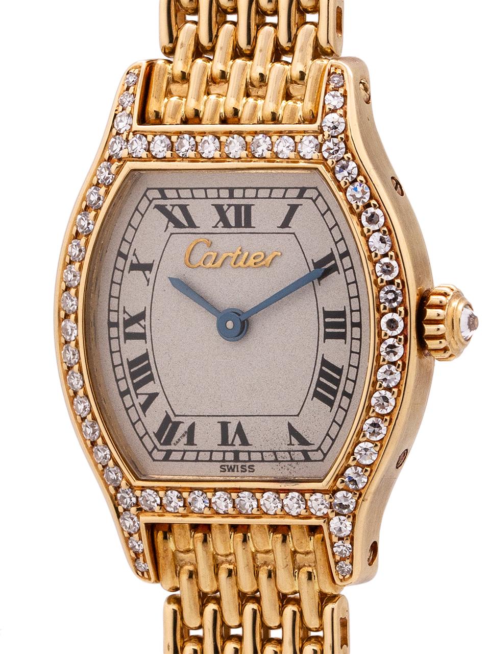 
A stunning lady’s Cartier Tortue in 18K yellow gold with elegant factory diamond set bezel and crown. Featuring a petite 20 x 27mm curved, tortoise shaped case, with slightly curved sapphire crystal, and classic Cartier diamond set crown., The