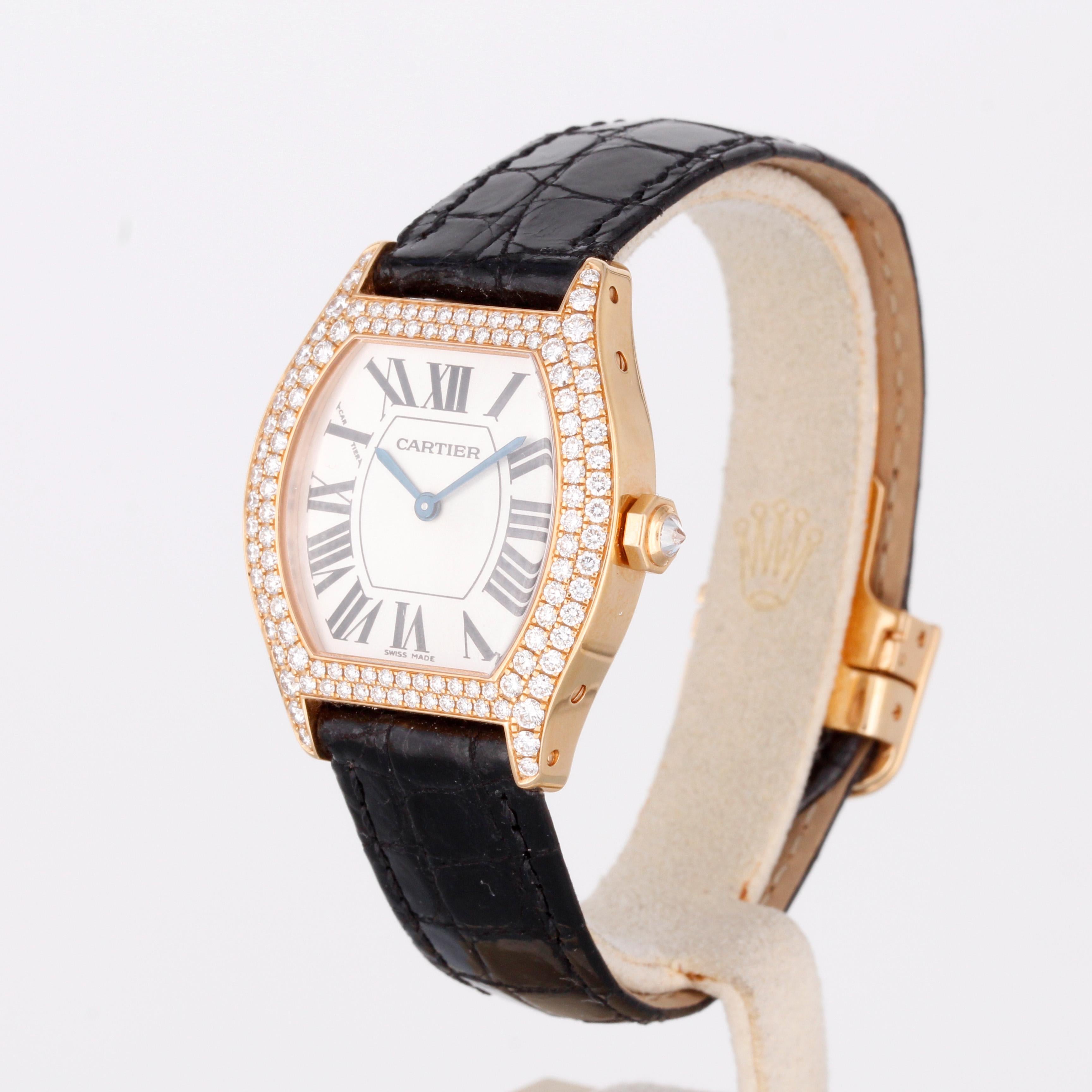 Cartier Tortue Ladies Watch with Diamond Bezel
Reference: WA505031
Material: Yellow gold
Movement: Manual winding
Diameter: 28x34mm
Dial: White
Bracelet: Crocodile leather with an 18ct. yellow gold folding clasp
Diamonds: Original