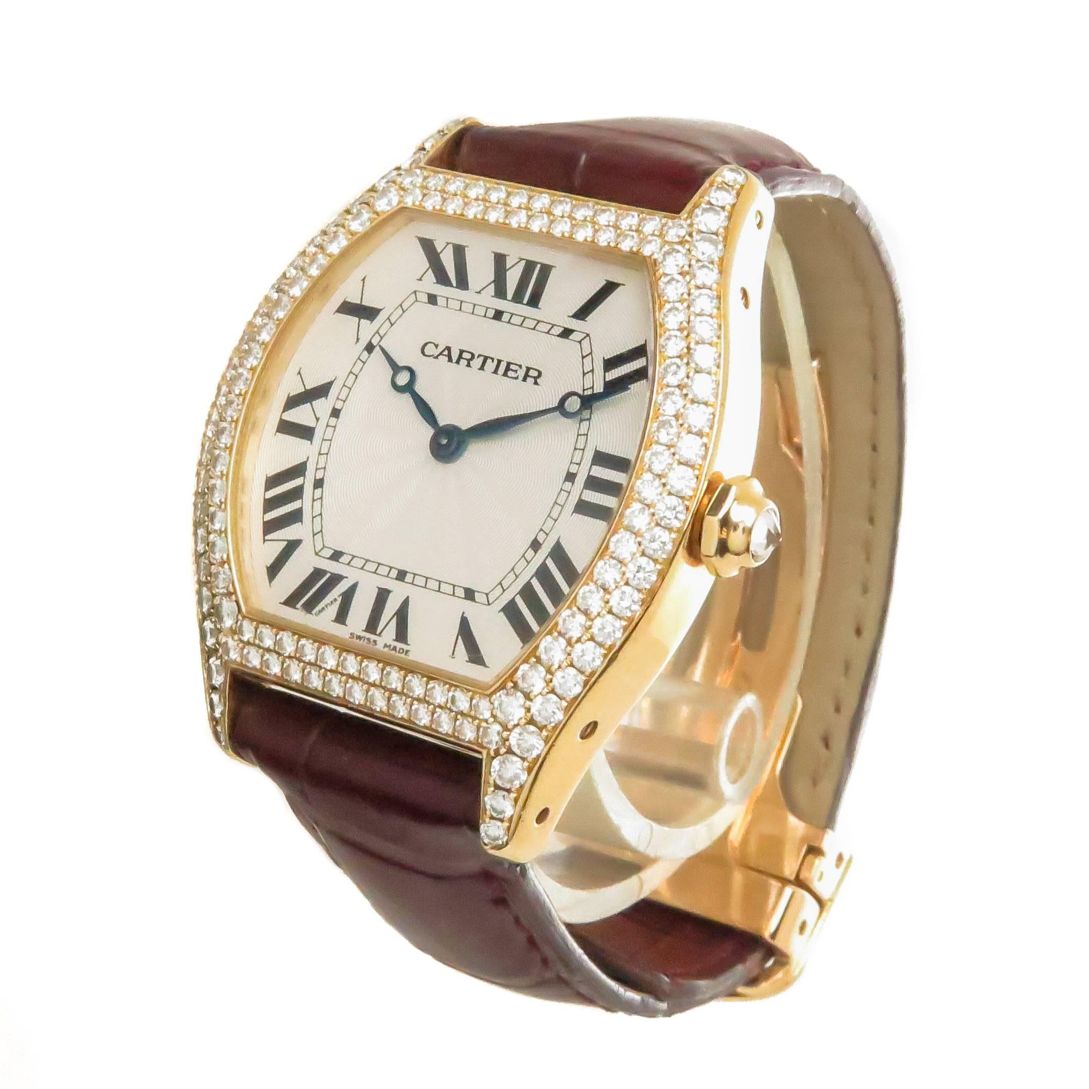 Circa 2009 Cartier Tortue Collection Reference 2496 Wrist Watch,  43 X 34 MM 18K Yellow Gold Water Resistant Case with see through Exhibition back. Double Row Diamond set Bezel totaling approximately 3 carats and a Diamond set Crown. Mechanical,