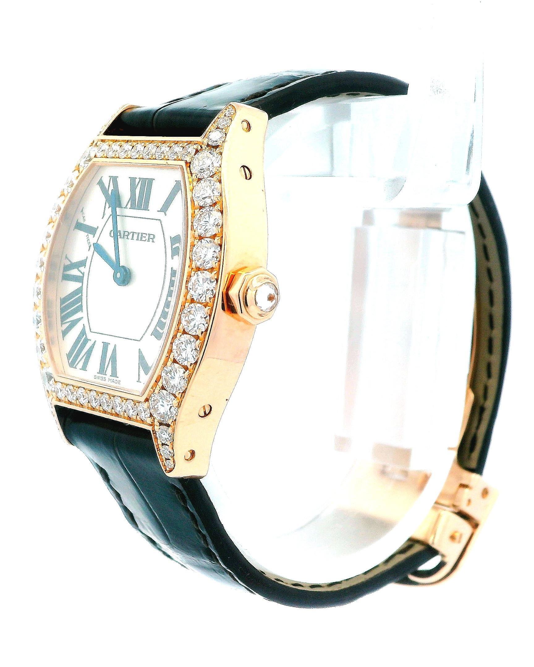 Cartier Tortue WA507031 / 2645 Ladies Watch. 28mm 18K rose gold case with factory diamond set. Silver dial with blue hands and black Roman numeral hour markers. Dark-Brown strap with 18K rose gold deployment clasp. It will fit up to a 6-Inch wrist.