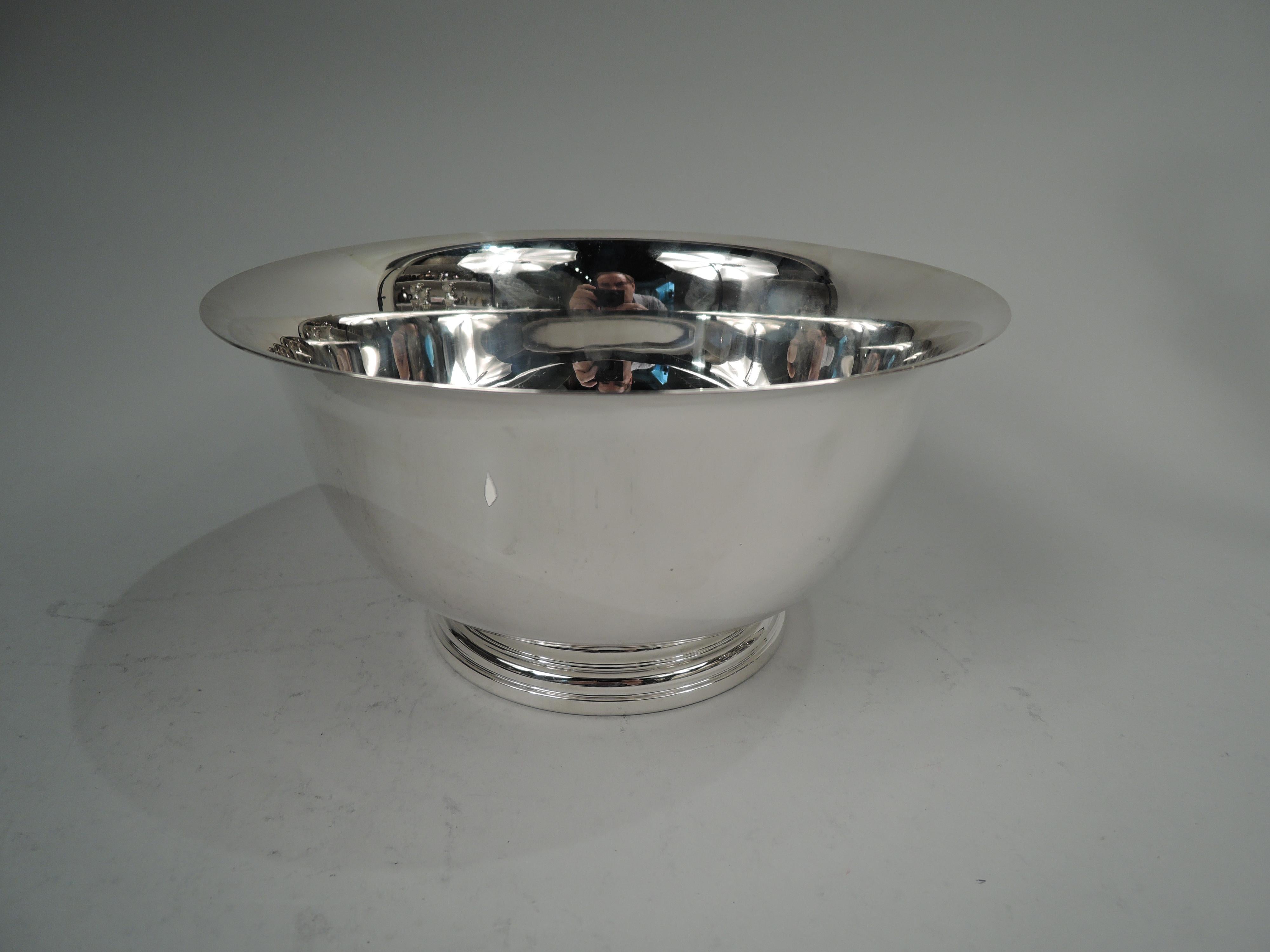 American Colonial sterling silver bowl, ca 1960, Retailed by Cartier in New York. Traditional Revere form with flared rim, curved bottom, and stepped foot. Marked “Cartier / Sterling / A Paul Revere / Reproduction / 9169”. Weight: 15.6 troy ounces.