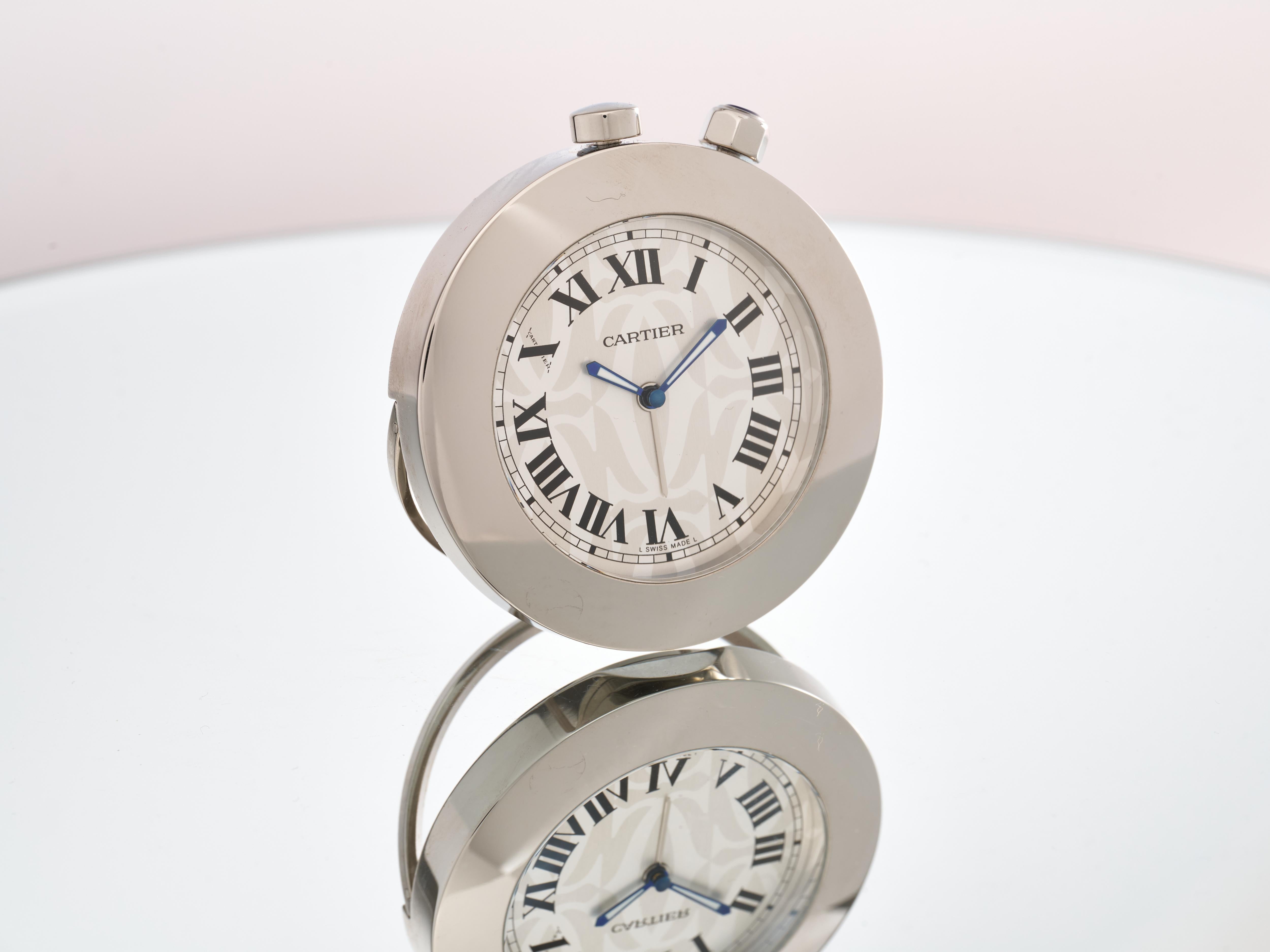 Cartier 
C De Cartier
Pendulette de Voyage

Logo Dial

Limited Edition

Reference 2751 or W0100054/1355 

Travel Desk Clock with Alarm 

White Dial with Roman Numeral Indices  with a Cartier Logo Print in the background

Polished Stainless Steel