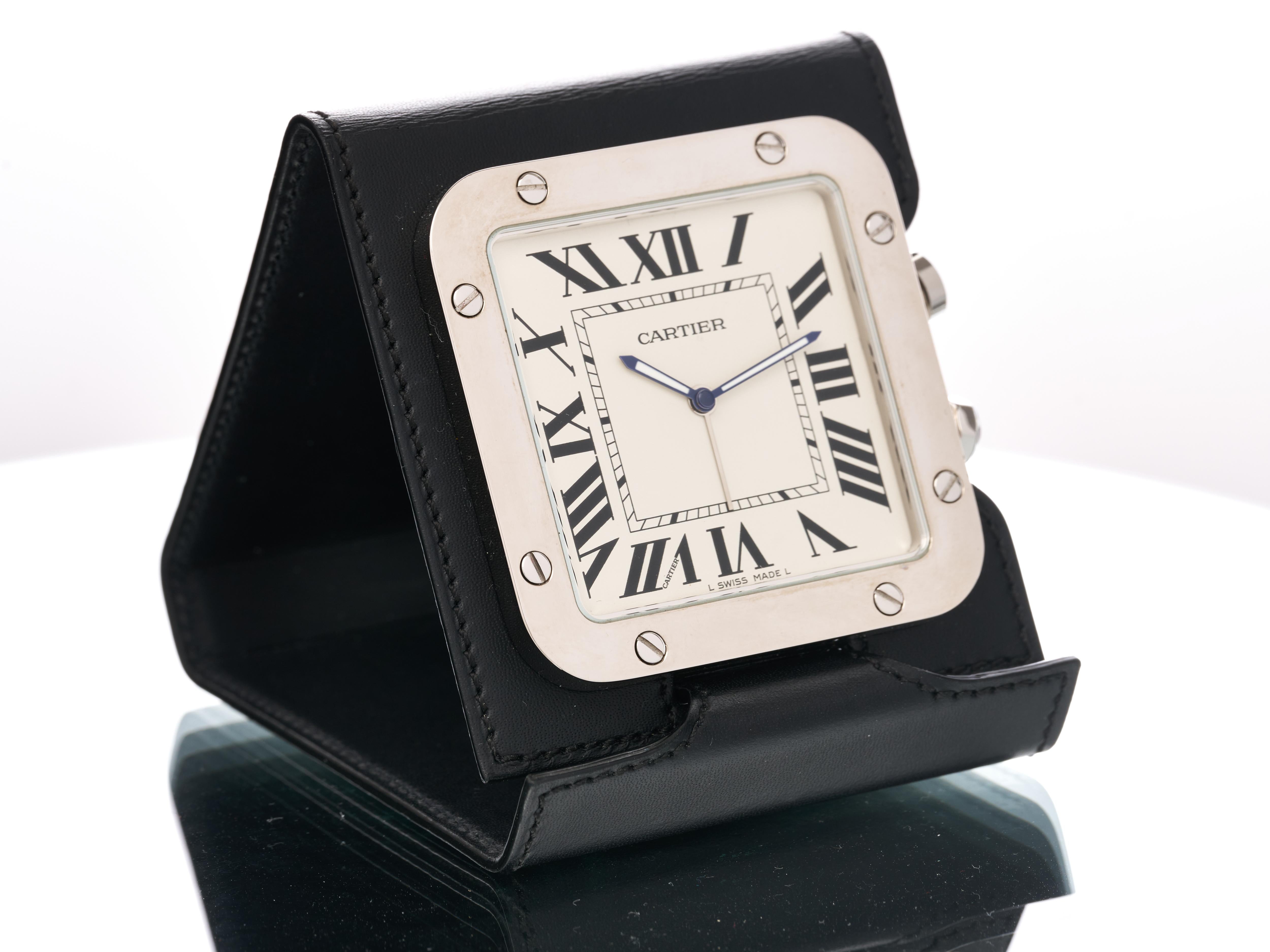 Fork In Time is proud to offer on the 1st Dibs marketplace:


Cartier 
Santos

Travel Desk Clock with Alarm 

Reference 2750


White Dial with Roman Numeral Indices 

Polished Stainless Steel Front and sides with Brushed Steel reverse

Leather Stand