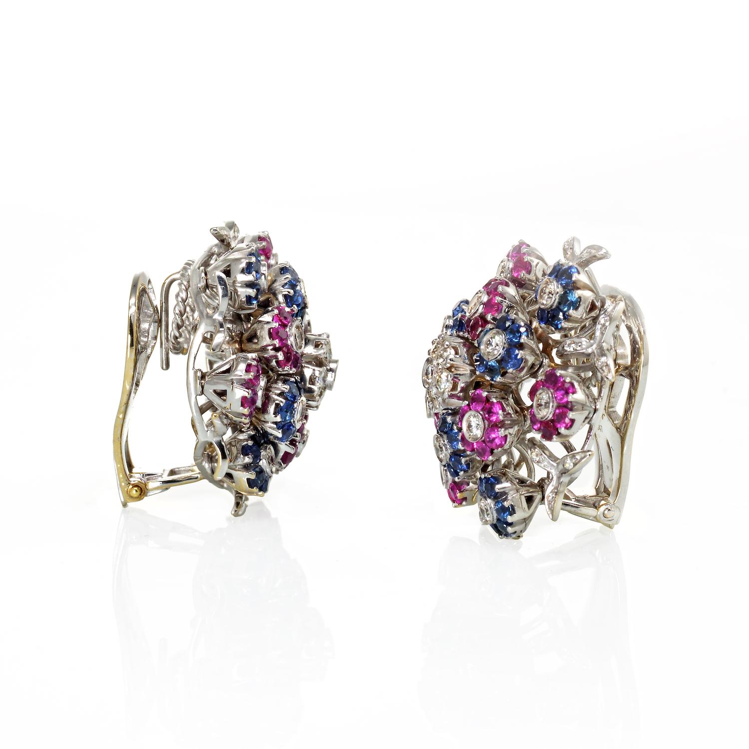 Step into the world of vintage elegance with these stunning Cartier Tremblant 18K White Gold Diamond, Sapphire, and Ruby Clip-On Earrings, a true testament to timeless design and craftsmanship. This pair of retro Cartier earrings showcases a