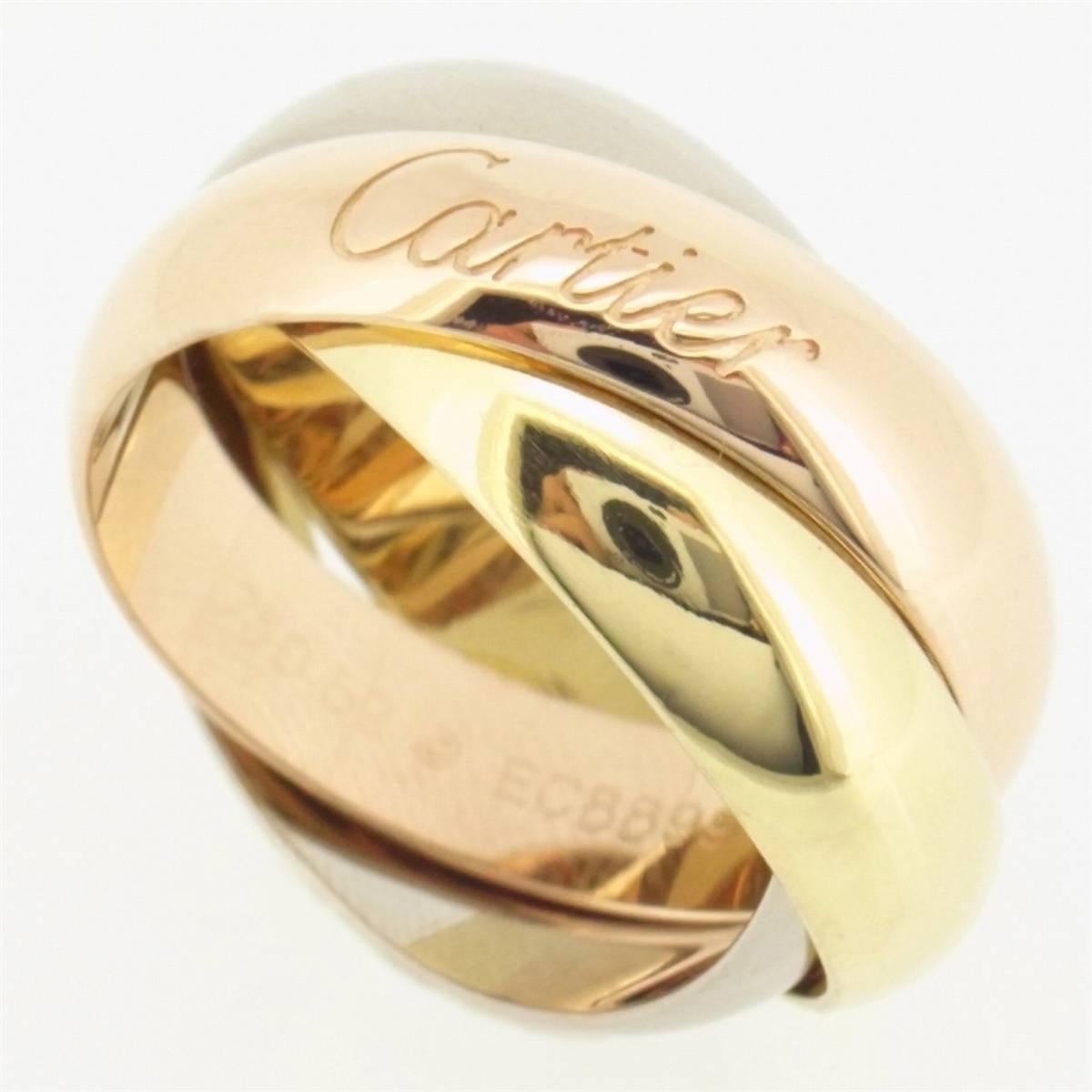 Cartier Trinity ring with three 18 karat gold bands in pink, yellow and white gold. Large model with band width measuring 5mm. 

Ring size is approximately 6 but will fit a 6.25 as well. 

Stamped European size 49 inside. 

100% Authentic. There are