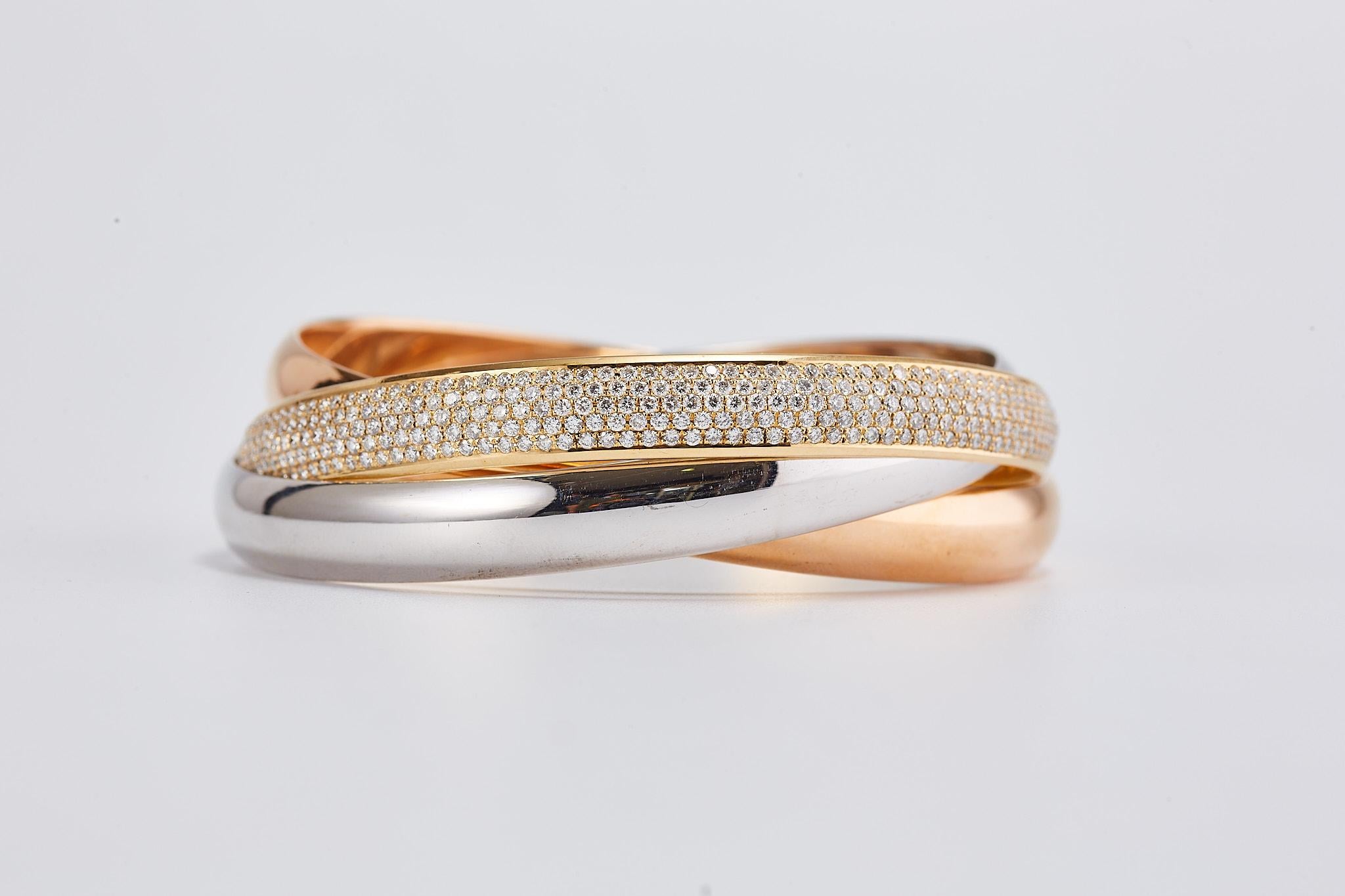 CARTIER Tri-Color Diamond Trinity Bangle Bracelet

Three bands. Three types of gold. Intertwined in harmony. The visionary mind of Louis Cartier introduced the Trinity collection in 1924. The unique, timeless, and cosmic Trinity design, depicted in