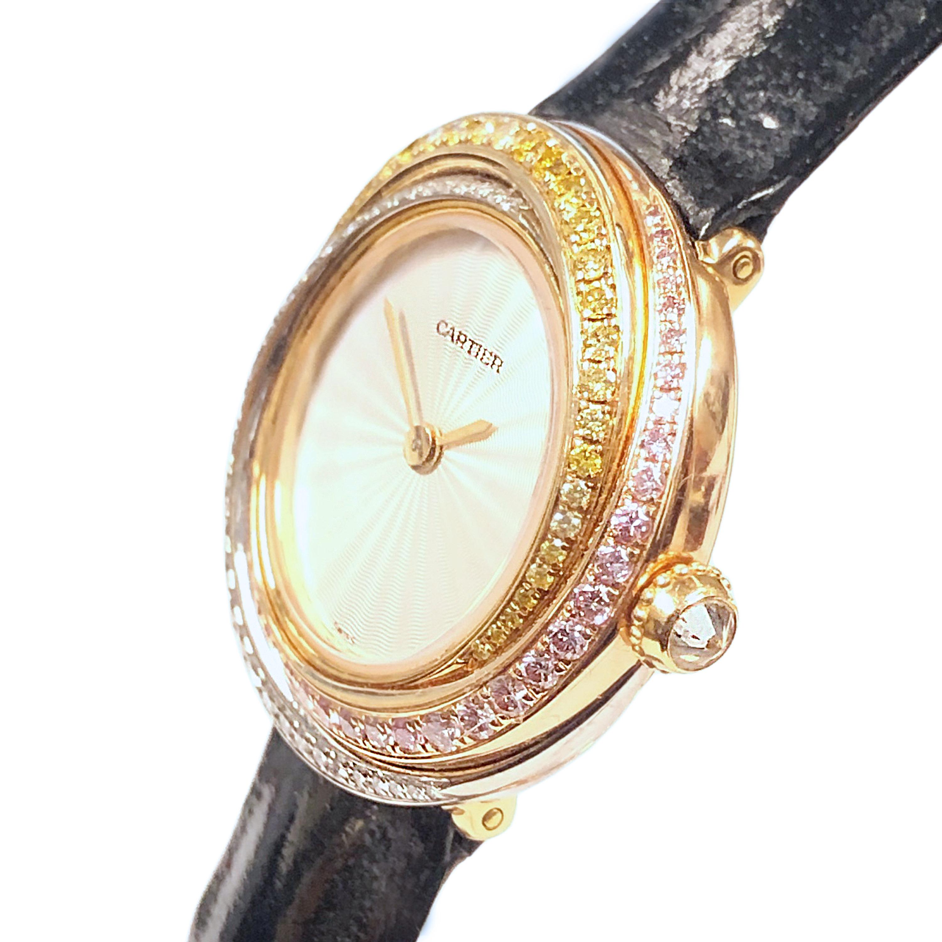 Circa 2010 Cartier Trinity collection Ladies Wrist watch, 27 MM 18K White, Yellow and Rose Gold Water resistant Case, Diamond set Crown.  Set with White and Natural Fancy Color Pink and Yellow Diamonds. Quartz Movement, Silver satin, Guilloche,
