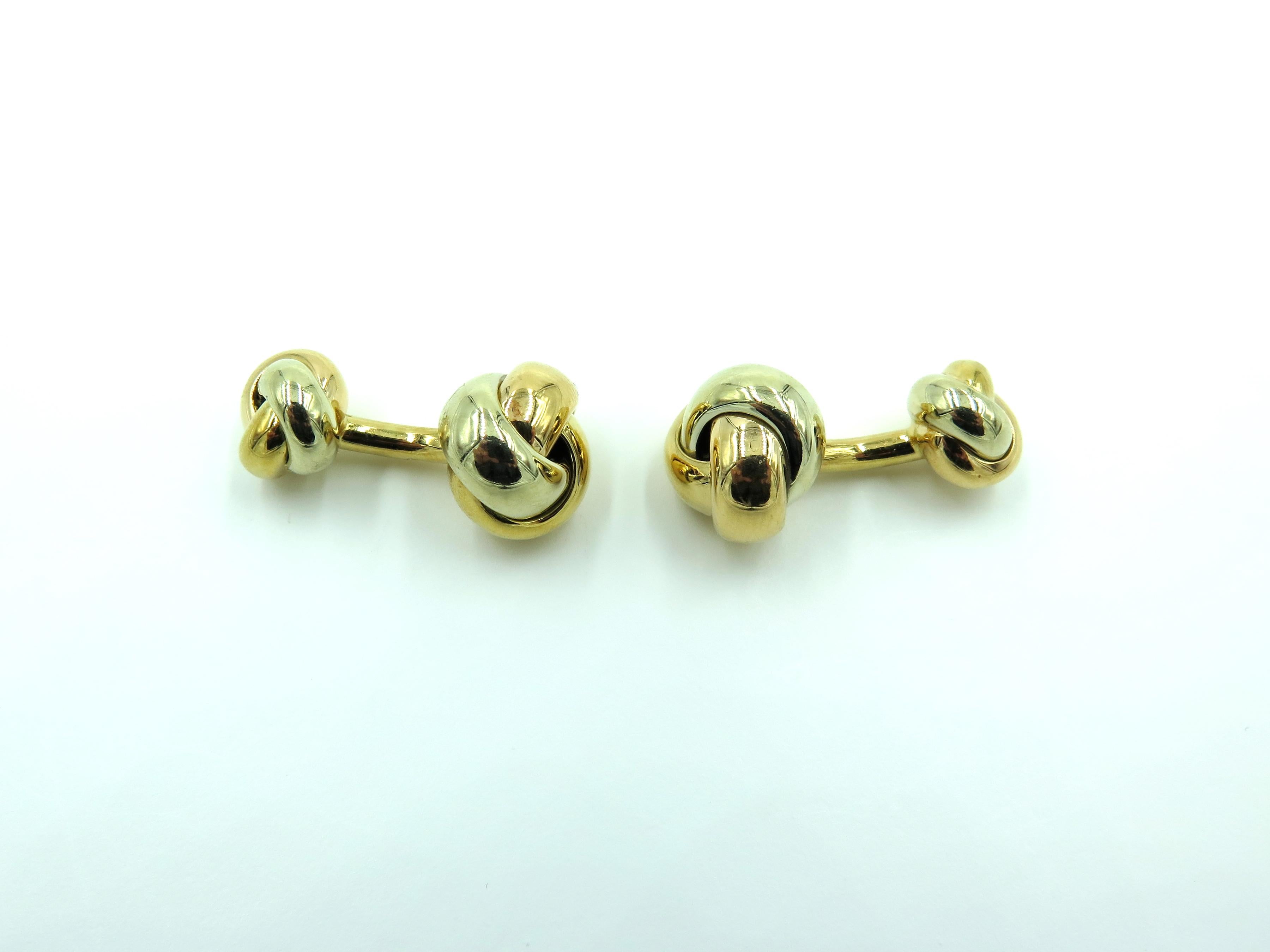 A pair of 18 karat tri color gold Trinity knot cufflinks. Cartier. Italy. Each designed as a rose, yellow and white gold knot, joined by a bar to a smaller knot. Larger links measures approximately 1/2 inch. Gross weight is approximately 19.0 grams.