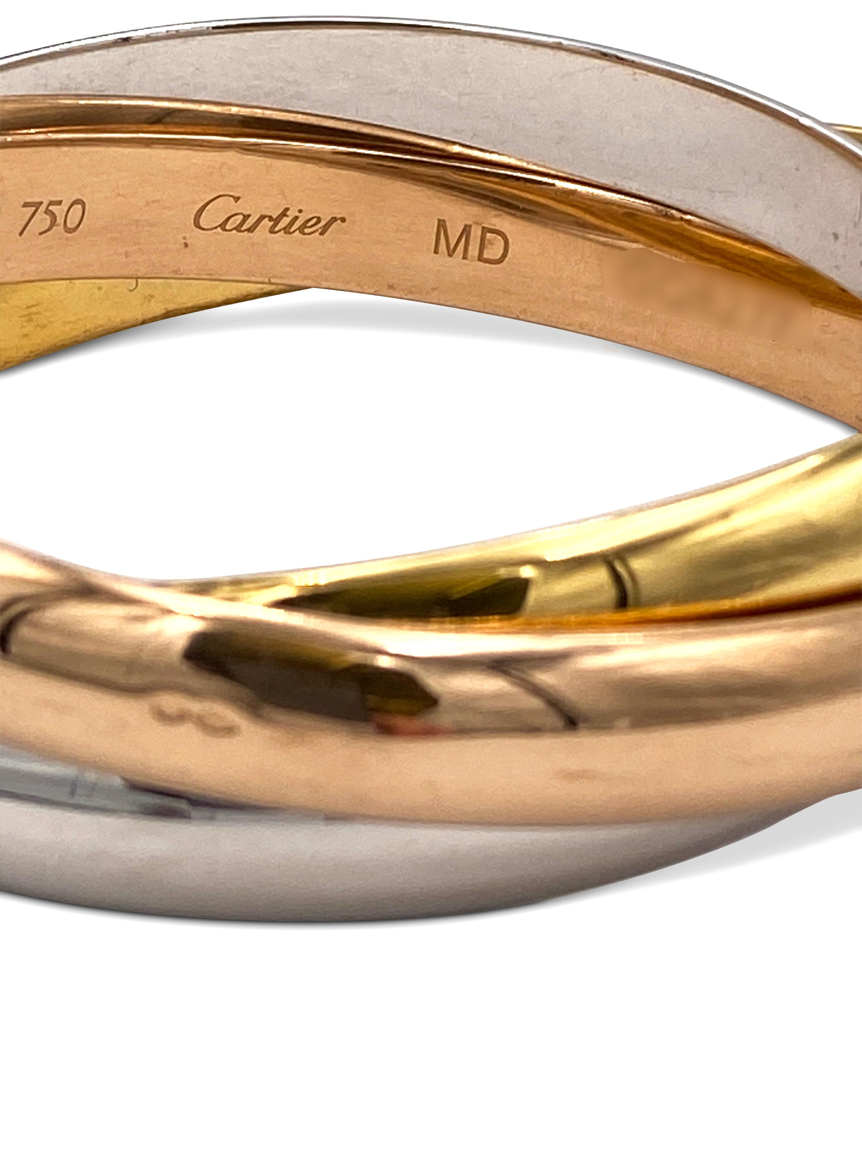 Authentic Cartier Trinity rolling bracelet crafted in 18 karat white, yellow, and rose gold. Each ring measures 9mm in width. Bracelet will fit up to size 7 1/2 comfortably. Stamped 750, Cartier, with serial number and import marks. Bracelet is