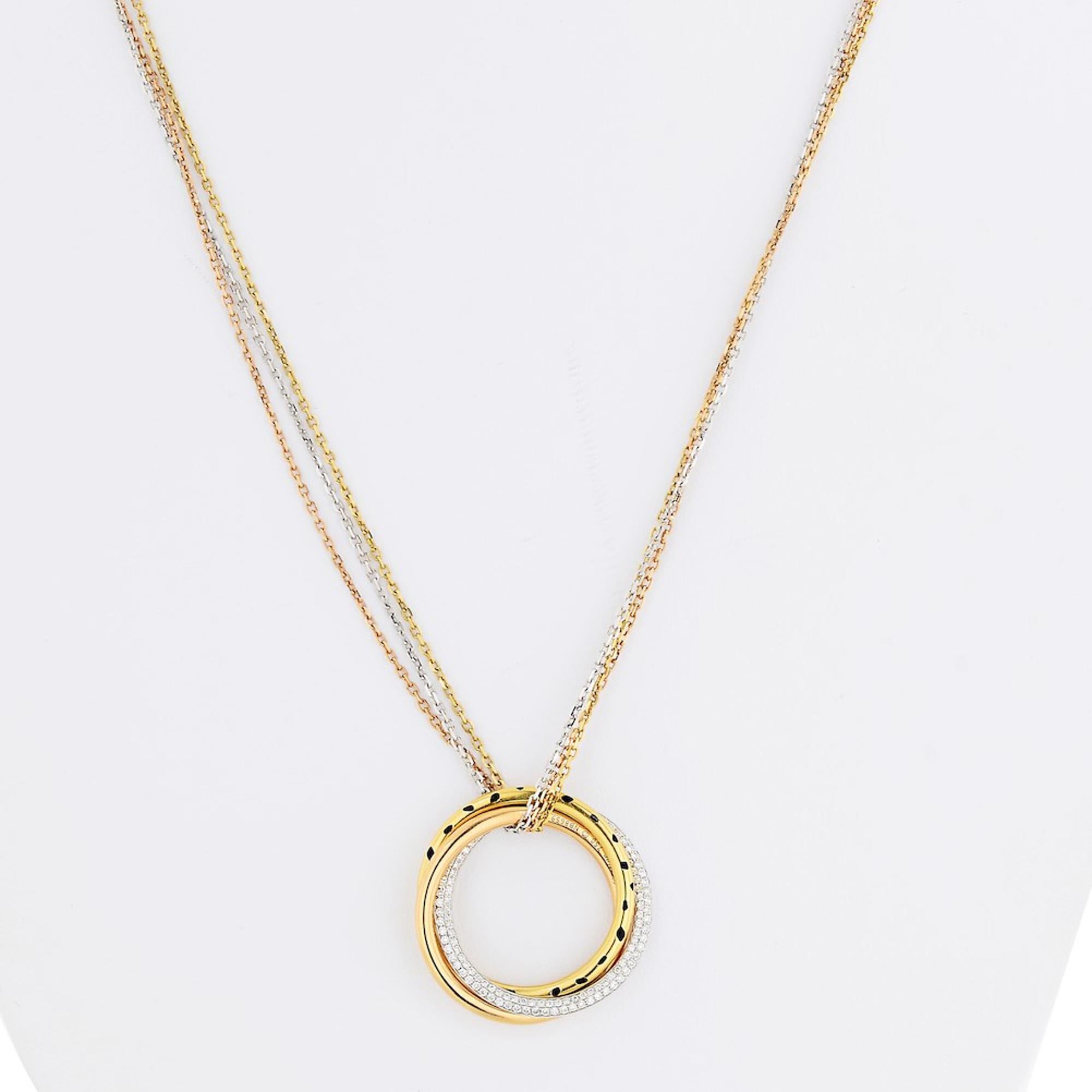 18k white, yellow and pink gold Cartier pendant necklace from the trinity collection. This statement piece features interlocking tricolor rings embellished with black lacquer and accented with round brilliant cut diamonds weighing approx. 0.88cts in