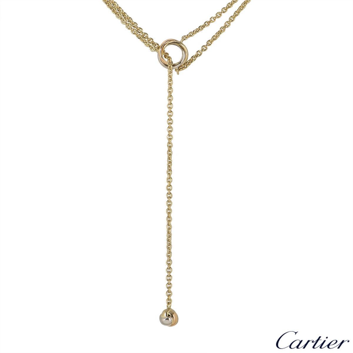 An 18k tri-colour gold necklace by Cartier from the Baby Trinity collection. The necklace features 3 iconic trinity rings intertwined with each other with a knot motif suspended at the bottom which can be adjusted in length. The necklace has a total
