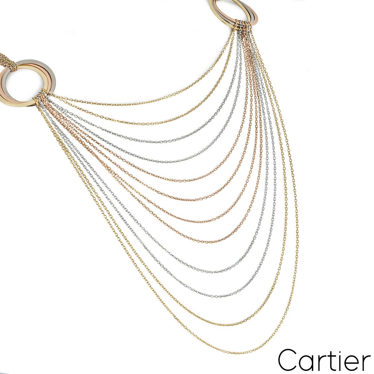 An eye-catching 18k tri-colour gold necklace by Cartier from the Trinity de Cartier collection. The necklace is composed of 12 yellow gold, rose gold and white gold graduating chains suspended from two evenly spaced iconic Trinity motifs. The