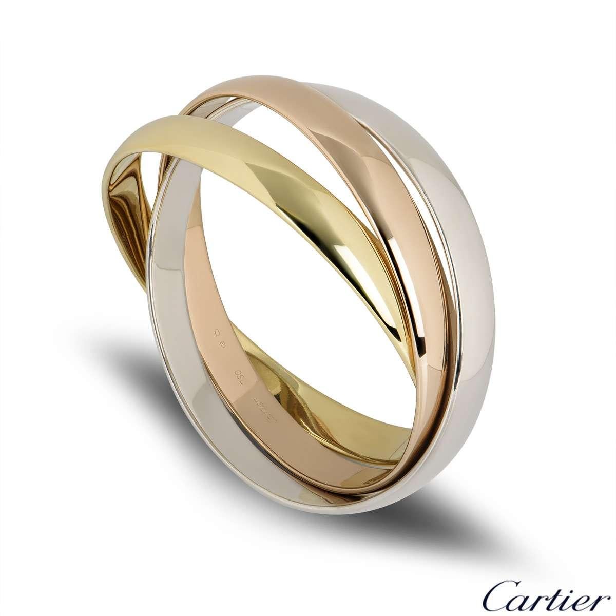 An iconic 18k tri-colour gold Cartier bangle from the Trinity de Cartier collection. The bracelet is made up of three intertwined 18k rose, white and yellow gold 9mm bands. The bracelet will fit a wrist size of up to 19cm and has a gross weight of