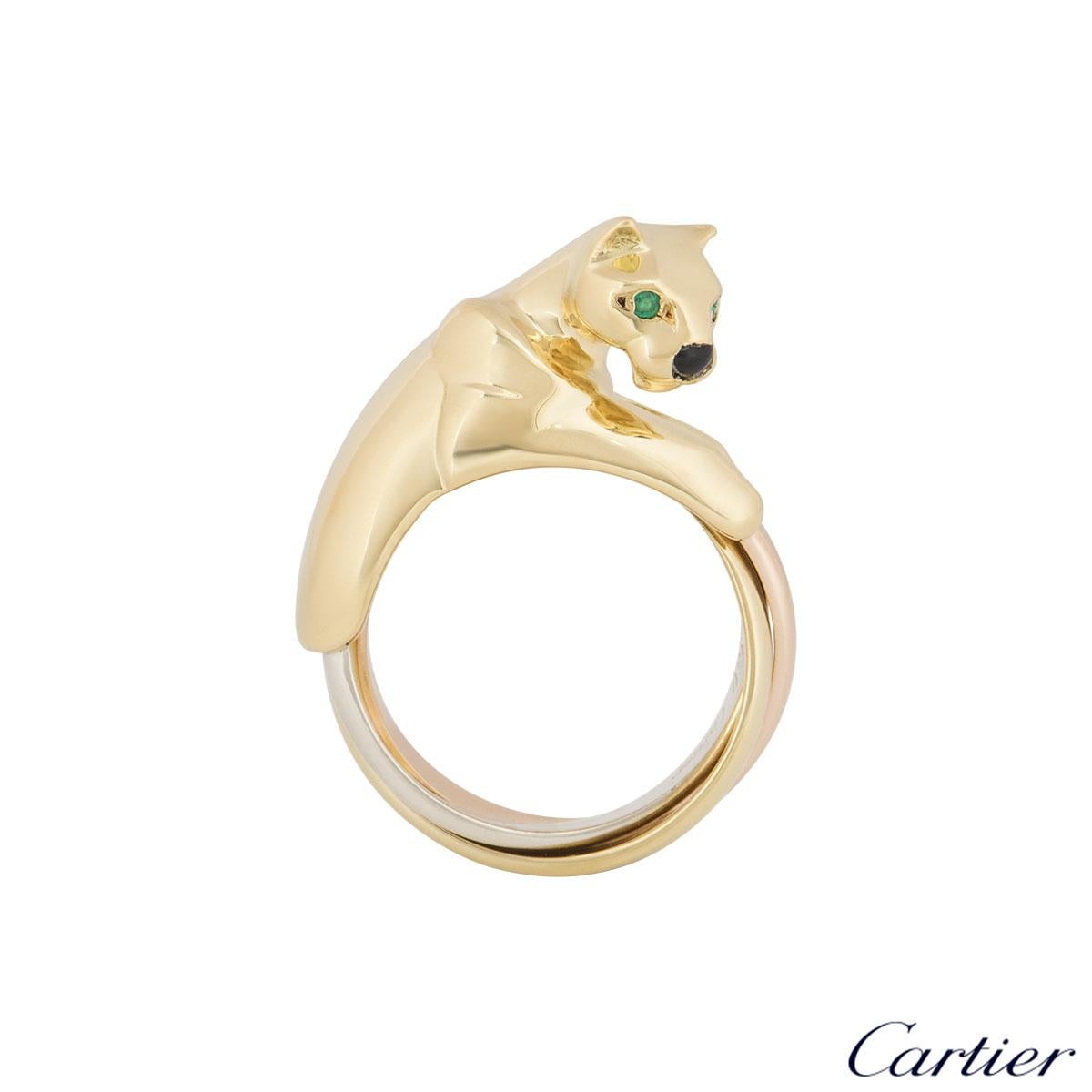 A beautiful 18k tri-colour gold panthere ring by Cartier from the Panthere collection. The ring is composed of a panthere head motif and is complemented with two round emeralds set as the eyes and onyx for the nose with the Trinity style body